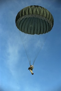 U.S. Army Staff Sgt. Robert Bylek, a paratrooper from the 82nd Airborne Division, steers into the wind after parachuting out of a C-17 aircraft from Charleston Air Force Base, S.C. at North Auxiliary Airfield near North, S.C., during a strategic brigade airdrop exercise Dec. 16, 2009. Airborne Soldiers from the 82nd Airborne Division, Ft. Bragg, N.C., were airdropped in the exercise along with cargo pallets to simulate the seizure of a remote airfield, providing a joint training opportunity for the Airmen and Soldiers. The training mission included airdrops over North Auxiliary Airfield, aerial refueling training and simulated aeromedical evacuation. (U.S. Air Force photo/Tech. Sgt. William Greer)