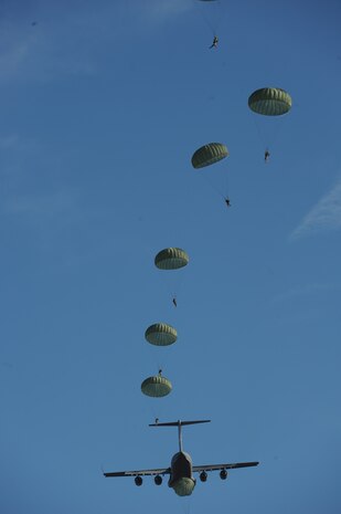 A C-17 aircraft from Charleston Air Force Base, S.C. conducts Operation Thunderstruck, a strategic brigade airdrop exercise over North Auxiliary Airfield near North, S.C., Dec. 16, 2009, demonstrating the global projection of U.S. airpower. Airborne Soldiers from the 2-319th Airborne Field Artillery, 82nd Airborne Division, Ft. Bragg, N.C., were airdropped in the exercise along with cargo pallets to simulate the seizure of a remote airfield, providing a joint training opportunity for the Airmen and Soldiers. The training mission included airdrops over North Auxiliary Airfield, aerial refueling training and simulated aeromedical evacuation. (U.S. Air Force photo/Airman 1st Class Asha McMakin)(Released)