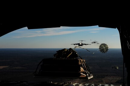 C-17 aircraft from Charleston Air Force Base, S.C., conduct Operation Thunderstruck over North Auxiliary Airfield near North, S.C., Dec. 16, 2009, demonstrating the global projection of U.S. airpower. Airborne Soldiers from the 2-319th Airborne Field Artillery, 82nd Airborne Division, Ft. Bragg, N.C., were air dropped in the exercise along with cargo pallets to simulate the seizure of a remote airfield, providing a joint training opportunity for the Airmen and Soldiers. The training mission included airdrops over North Auxiliary Airfield, aerial refueling training and simulated aero medical evacuation. (U.S. Air Force photo/Staff Sgt. Joshua L. DeMotts)(Released)

