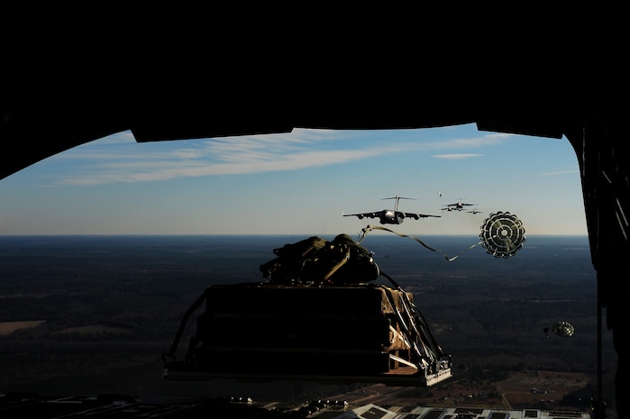 C-17 aircraft from Charleston Air Force Base, S.C., conduct Operation Thunderstruck over North Auxiliary Airfield near North, S.C., Dec. 16, 2009, demonstrating the global projection of U.S. airpower. Airborne Soldiers from the 2-319th Airborne Field Artillery, 82nd Airborne Division, Ft. Bragg, N.C., were air dropped in the exercise along with cargo pallets to simulate the seizure of a remote airfield, providing a joint training opportunity for the Airmen and Soldiers. The training mission included airdrops over North Auxiliary Airfield, aerial refueling training and simulated aero medical evacuation. (U.S. Air Force photo/Staff Sgt. Joshua L. DeMotts)(Released)