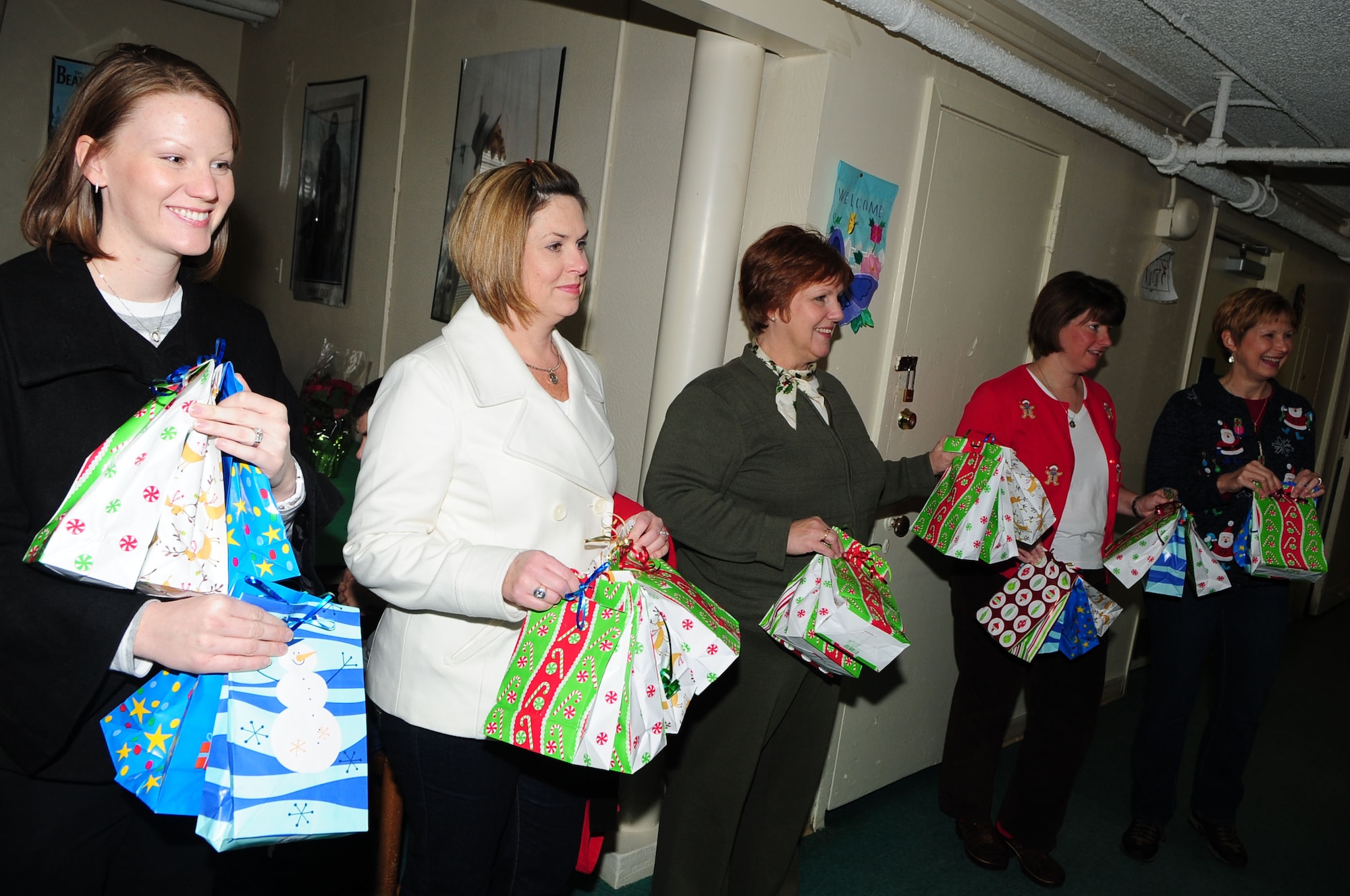 BARKSDALE AIR FORCE BASE, La. – Members of the Barksdale Officer’s Spouses Club prepare to pass gifts off to Santa Claus so they can be presented to clients of the Handicapped Are Producers House during their holiday party, Dec. 11. The BOSC raised funds to give the men and women of HAP House a break to enjoy their holiday season. (U.S. Air Force photo by Senior Airman Joanna M. Kresge)