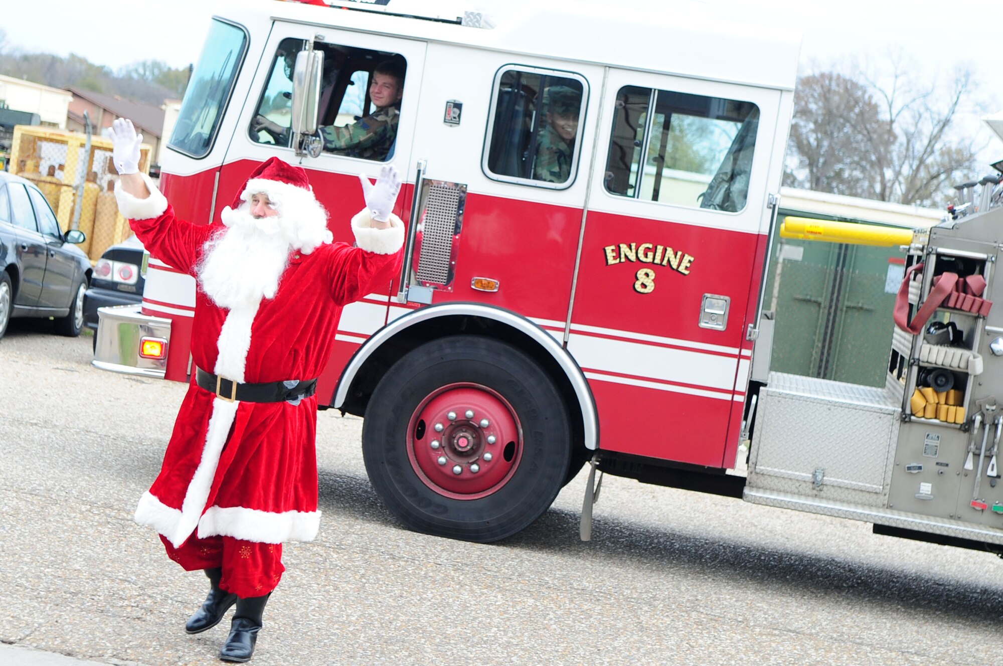 BARKSDALE AIR FORCE BASE, La. – Santa disembarks a Barksdale fire engine and waves to the clients of the Handicapped Are Producers House during their holiday party, Dec. 11. HAP House is a non-profit organization that provides mentally and physically handicapped persons  the chance to socialize and work for a living in a safe environment. (U.S. Air Force photo by Senior Airman Joanna M. Kresge)