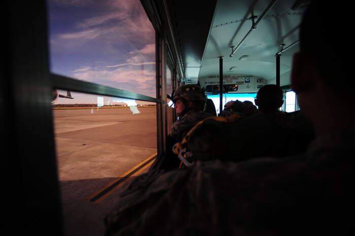 U.S. Army Spc. Katelyn Jovani of the 2-319th Airborne Field Artillery, 82nd Airborne Division, Ft. Bragg, N.C., looks at aircraft on the Charleston Air Force Base flightline. C-17 aircraft from Charleston Air Force Base, S.C., conducted a strategic brigade airdrop exercise over North Auxiliary Airfield near North, S.C., Dec. 16, 2009, demonstrating the global projection of U.S. airpower. Airborne Soldiers from the 2-319th Airborne Field Artillery, 82nd Airborne Division, Ft. Bragg, N.C., were airdropped in the exercise along with cargo pallets to simulate the seizure of a remote airfield, providing a joint training opportunity for the Airmen and Soldiers. The training mission included airdrops over North Auxiliary Airfield, aerial refueling training and simulated aeromedical evacuation. (U.S. Air Force photo/Tech. Sgt. Adrian Cadiz) (Released) 