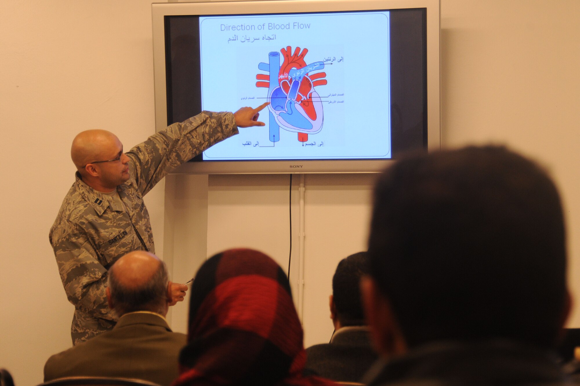 Capt. Fredrick Santillan explains the cardiopulmonary system to Iraqi nurses and nursing students Dec. 9, 2009, at the Air Force Theater Hospital at Joint Base Balad, Iraq. The class was part of the Iraqi Nursing Partnership Program, aimed to teach Iraqis modern medical techniques once a month. The students begin each class with a lecture covering the day's primary topic and then complete a hands-on portion, when they put those teachings into practice. Captain Santillan is a 332nd Expeditionary Medical Group registered nurse. (U.S. Air Force photo/Airman 1st Class Brittany Y. Bateman)