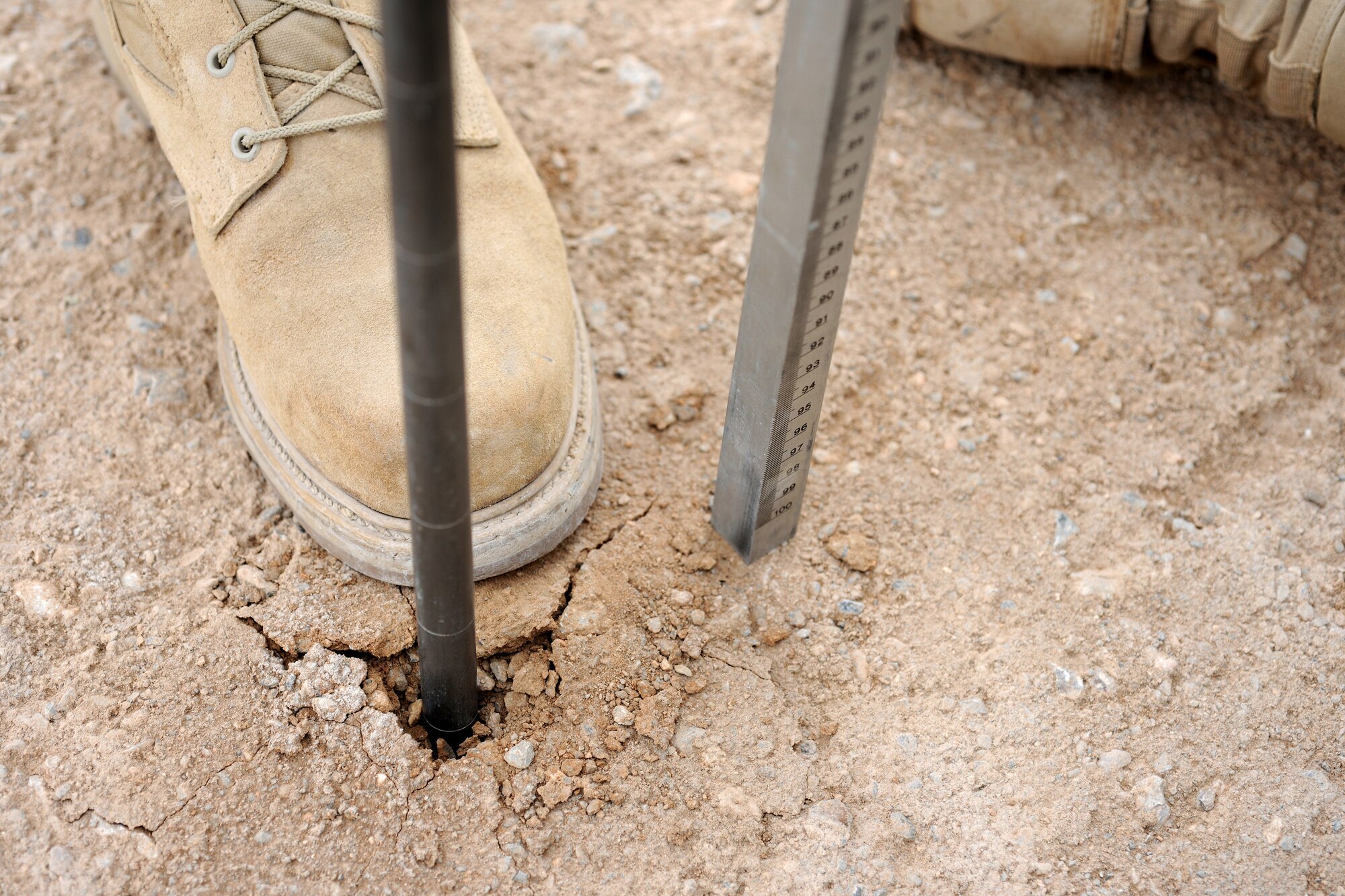 A dynamic cone penetrometer is used to measure the soil subsurface strength of the airfield at Forward Operating Base Farah, Afghanistan, Dec. 2, 2009. The soil analysis along with airfield gradient measurements will be part of a complete report compiled by an Air Force airfield assessment team from the 621st Contingency Response Wing at Joint Base McGuire, N.J. The team of 12 Airmen deployed to Afghanistan for a 45-day tour to visit all established airfields with a major military presence with the goal of helping the International Security Assistance Force commander understand how to get more people and cargo into the war zone and then sustain those forces once they are in place. (U.S. Air Force photo)
