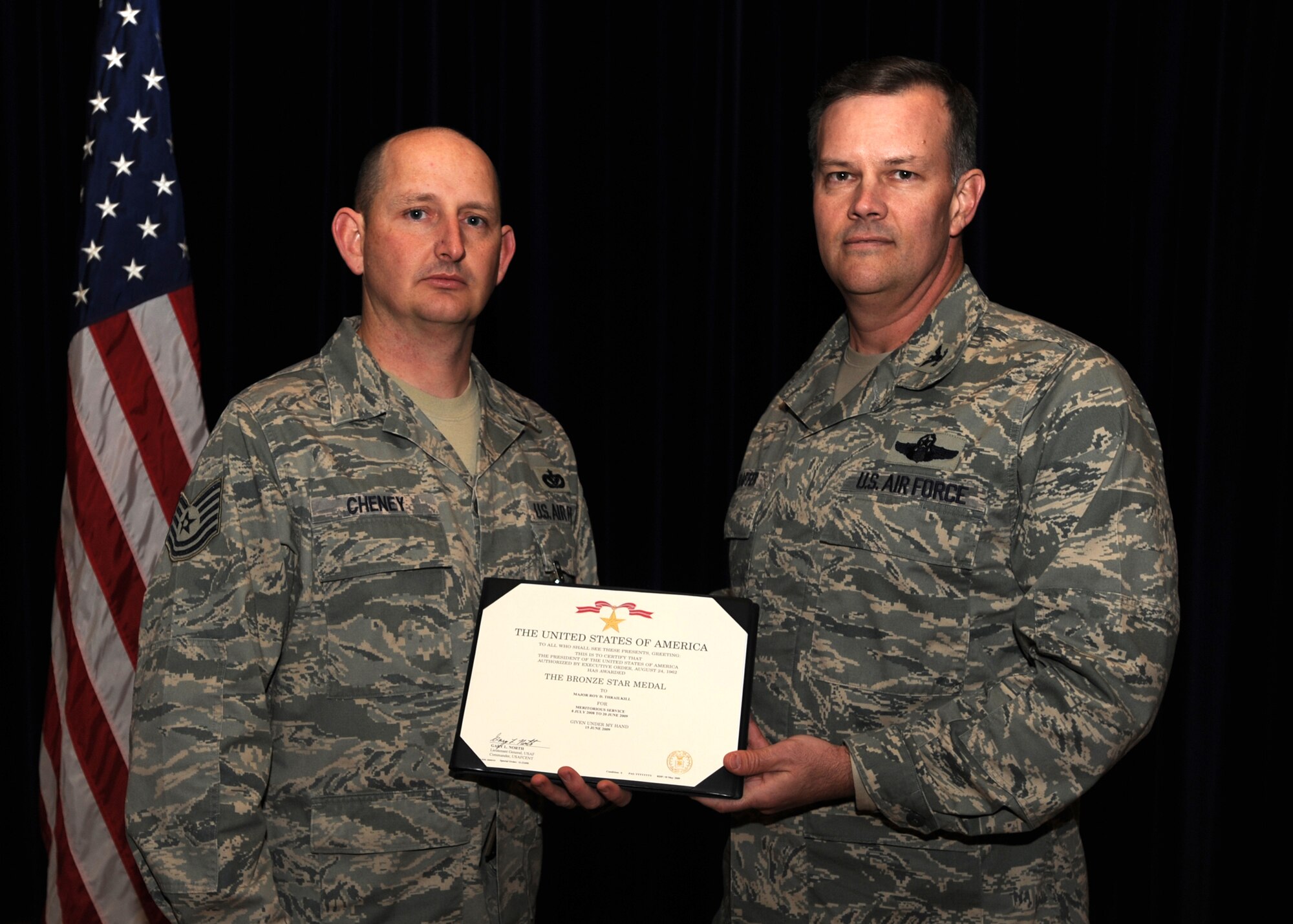 Col. Don Shaffer, 319th Air Refueling Wing commander, presents Tech. Sgt. David L. Cheney, 319th Civil Engineer Squadron, with the Bronze Star award. Sergeant Cheney earned the award for his actions while deployed to Afghanistan. (U.S. Air Force photo by Staff Sgt. Suellyn F. Nuckolls)