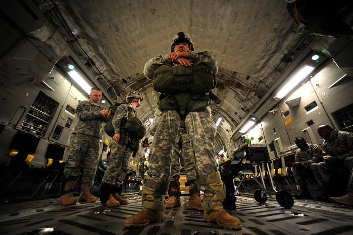 U.S. Army Specialist Leevan Dethsy from the 2-319th Airborne Field Artillery, 82nd Airborne Division, Ft. Bragg, N.C., is inspected by a jumpmaster before an airdrop during Operation Thunderstruck over North Auxiliary Airfield near North, S.C., Dec. 16, 2009, demonstrating the global projection of U.S. airpower. Airborne Soldiers from the 2-319th Airborne Field Artillery, 82nd Airborne Division, Ft. Bragg, N.C., were airdropped in the exercise along with cargo pallets to simulate the seizure of a remote airfield, providing a joint training opportunity for the Airmen and Soldiers. The training mission included airdrops over North Auxiliary Airfield, aerial refueling training and simulated aeromedical evacuation. (U.S. Air Force photo/Staff Sgt. Andy Kin)(Released)