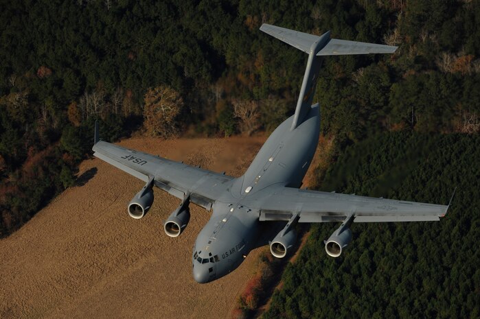 A U.S. Air Force C-17 aircraft performs a low-level maneuver during Operation Thunderstruck at Charleston Air Force Base S.C., Dec. 16, 2009. C-17 aircraft from Charleston AFB conducted a strategic brigade airdrop exercise over North Auxiliary Airfield near North, S.C., demonstrating the global projection of U.S. airpower. U.S. Army Airborne Soldiers from the 2-319th Airborne Field Artillery, 82nd Airborne Division, Ft. Bragg, N.C., were airdropped in the exercise along with cargo pallets to simulate the seizure of a remote airfield, providing a joint training opportunity for the Airmen and Soldiers. The training mission included airdrops over North Auxiliary Airfield, aerial refueling training and simulated aeromedical evacuation. (U.S. Air Force photo/Master Sgt. Andy Dunaway)(Released)