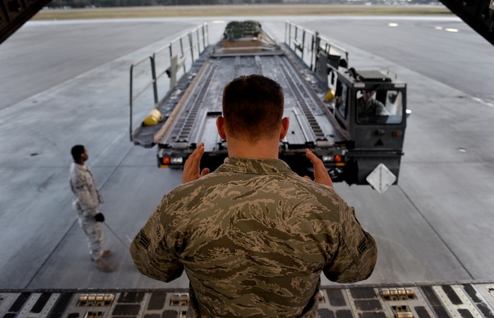 U.S. Air Force Airmen assigned to the 437th Airlift Wing load a training pallet into the cargo bay of a C-17 during Operation Thunderstruck Dec. 16, 2009, at Charleston Air Force Base, S.C. The 437th Airlift Wing and the 315th Airlift Wing conducted Operation Thunderstruck, a large formation exercise designed to prepare airmen for the deployed environment. The training mission included airdrops over North Auxiliary Airfield, air refueling and a simulated aero medical evacuation (U.S. Air Force photo/Staff Sgt. Shawn Weismiller)(Released)