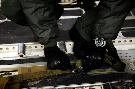 U.S. Air Force Staff Sgt. Thomas Elsworth, a loadmaster with the 16th Airlift Squadron, Charleston Air Force Base, S.C., secures rigging to a container delivery system.  C-17 aircraft from  Charleston AFB conducted a strategic brigade airdrop exercise over North Auxiliary Airfield near North, S.C., Dec. 16, 2009, demonstrating the global projection of U.S. airpower. Airborne Soldiers from the 2-319th Airborne Field Artillery, 82nd Airborne Division, Ft. Bragg, N.C., were air dropped in the exercise along with cargo pallets to simulate the seizure of a remote airfield, providing a joint training opportunity for the Airmen and Soldiers. The training mission included airdrops over North Auxiliary Airfield, aerial refueling training and simulated aero medical evacuation. (U.S. Air Force photo/Staff Sgt. Joshua L. DeMotts)(Released)

