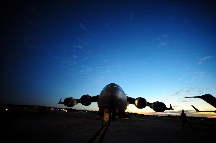 Early morning pre-flight checks are conducted on a Charleston Air Force Base C-17 before a strategic brigade airdrop exercise over North Auxiliary Airfield near North, S.C., Dec. 16, 2009, demonstrating the global projection of U.S. airpower. Airborne Soldiers from the 2-319th Airborne Field Artillery, 82nd Airborne Division, Ft. Bragg, N.C., were airdropped in the exercise along with cargo pallets to simulate the seizure of a remote airfield, providing a joint training opportunity for the Airmen and Soldiers. The training mission included airdrops over North Auxiliary Airfield, aerial refueling training and simulated aeromedical evacuation. (U.S. Air Force photo/ Staff Sgt. Joshua L. DeMotts) (Released)