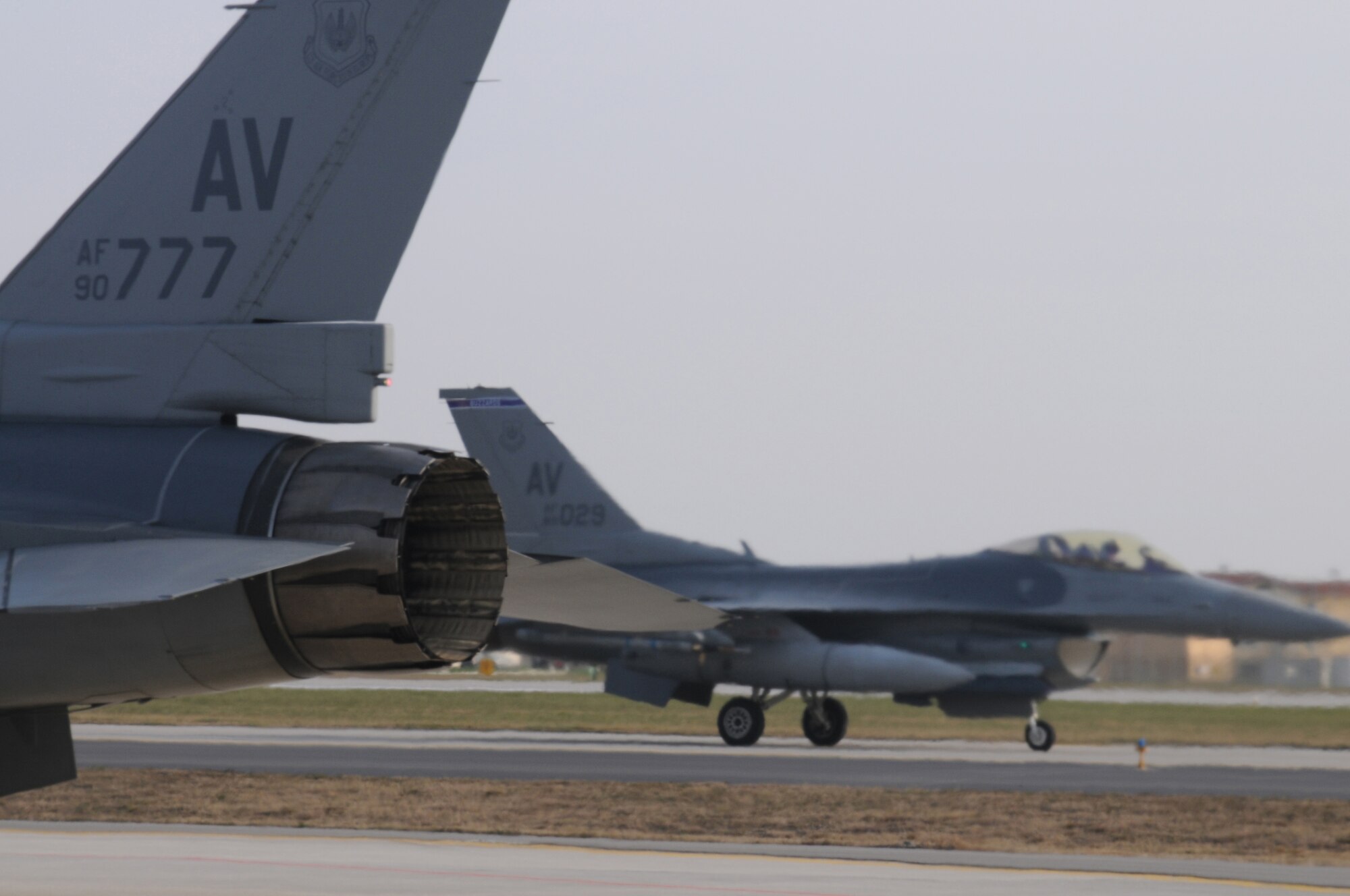 Two F-16 Fighting Falcons, assigned to the 510th Fighter Squadron, taxi to a hot pit for refueling during a surge, Dec. 15, 2009 at Aviano Air Base, Italy. The 31st Fighter Wing conducted the surge to test sortie production capability; allowing the wing to push its support functions to the limits, simulate pilot's war-time flying rates, and to help increase flying hours and sorties. The ultimate goal was to generate and fly maximum training sorties within a day.
(U.S. Air Force photo/ Senior Airman Nadine Y. Barclay)