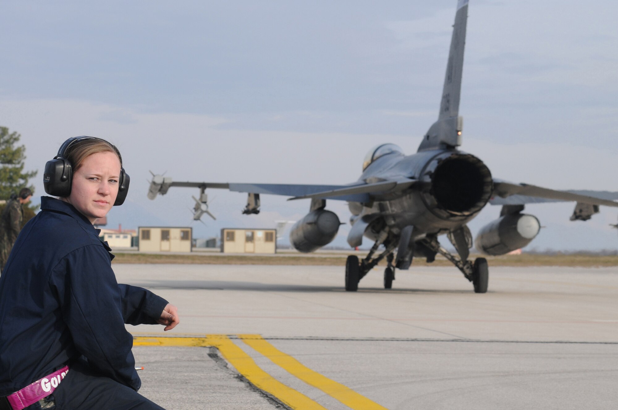 Airman 1st Class Lanora Goldy, 31st Aircraft Maintenance Squadron crew chief, waits for the next approaching F-16 Fighting Falcon during a surge on the flight line, Dec. 15, 2009 at Aviano Air Base, Italy. The 31st Fighter Wing conducted the surge to test sortie production capability; allowing the wing to push its support functions to the limits,simulate pilot's war-time flying rates, and to help increase flying hours and sorties. The ultimate goal was to generate and fly maximum training sorties within a day.


(U.S. Air Force photo/ Senior Airman Nadine Y. Barclay)