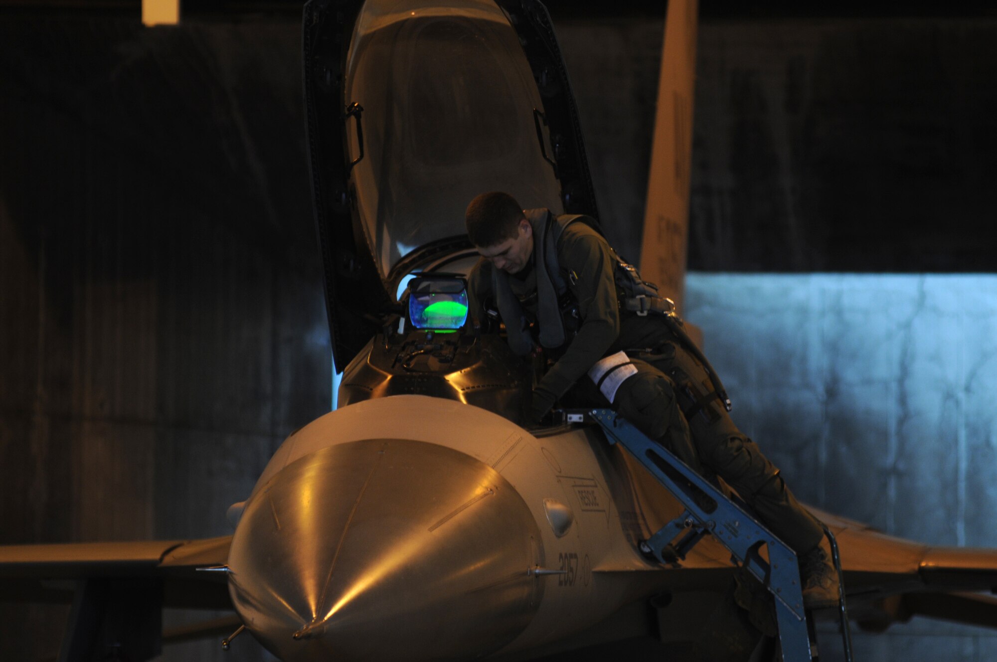 Capt. Tyler Robarge assigned to the 31st Operations Support Squadron, performs a pre-flight cockpit inspection of an F-16 Fighting Falcon, Dec. 16, 2009, during a surge at Aviano Air Base, Italy. The 31st Fighter Wing conducted the surge to test sortie production capability; allowing the wing to push its support functions to the limits, simulate pilot's war-time flying rates, and to help increase flying hours and sorties. The ultimate goal was to generate and fly maximum training sorties within a day.

(U.S. Air Force photo/ Senior Airman Nadine Y. Barclay)