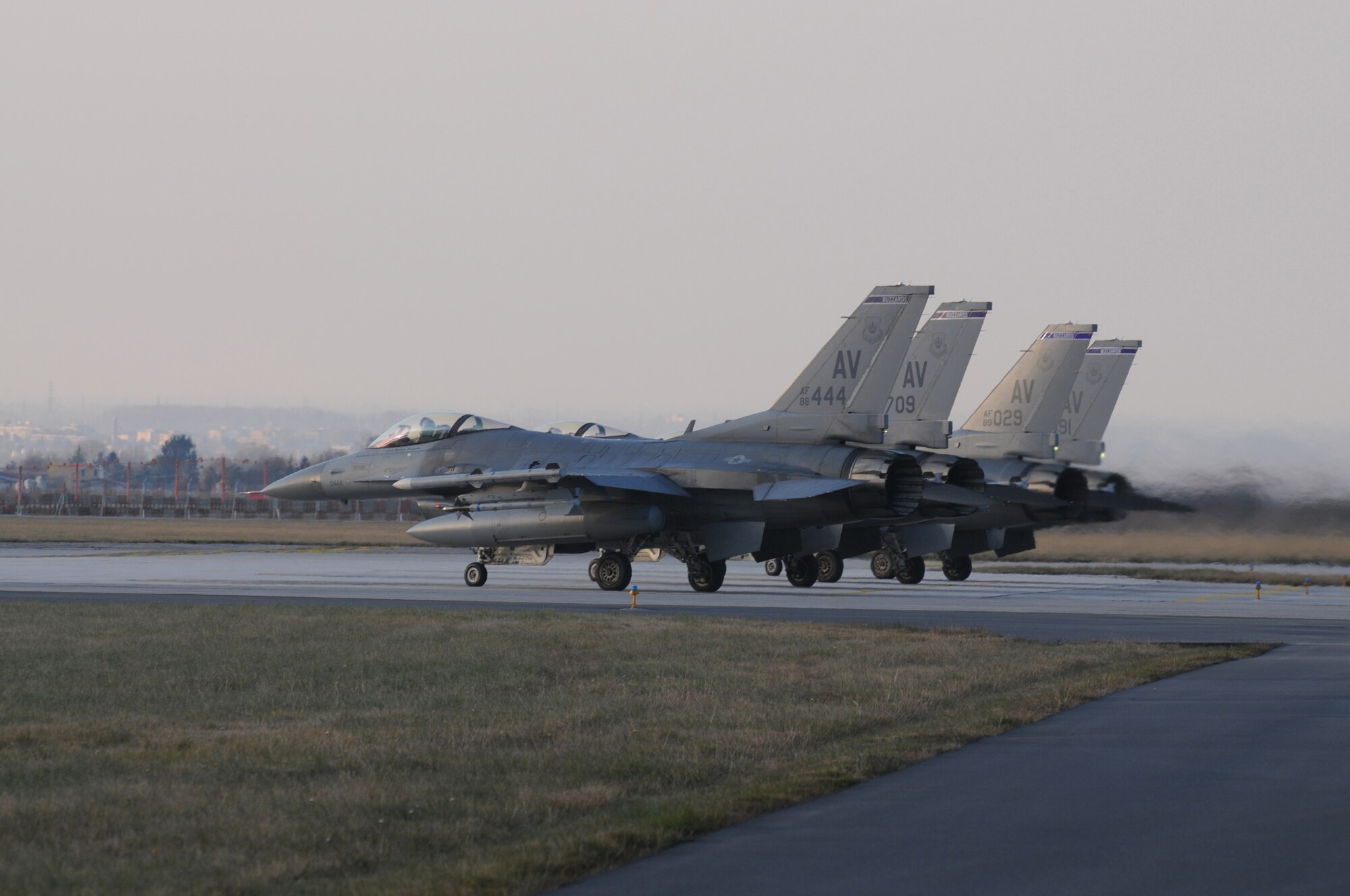 Four F-16 Fighting Falcons await tower approval for takeoff during a surge, Dec. 15, 2009 at Aviano Air Base, Italy. The 31st Fighter Wing conducted the surge to test sortie production capability; allowing the wing to push its support functions to the limits, simulate pilot's war-time flying rates, and to help increase flying hours and sorties. The ultimate goal was to generate and fly maximum training sorties within a day.
(U.S. Air Force photo/ Senior Airman Nadine Y. Barclay)