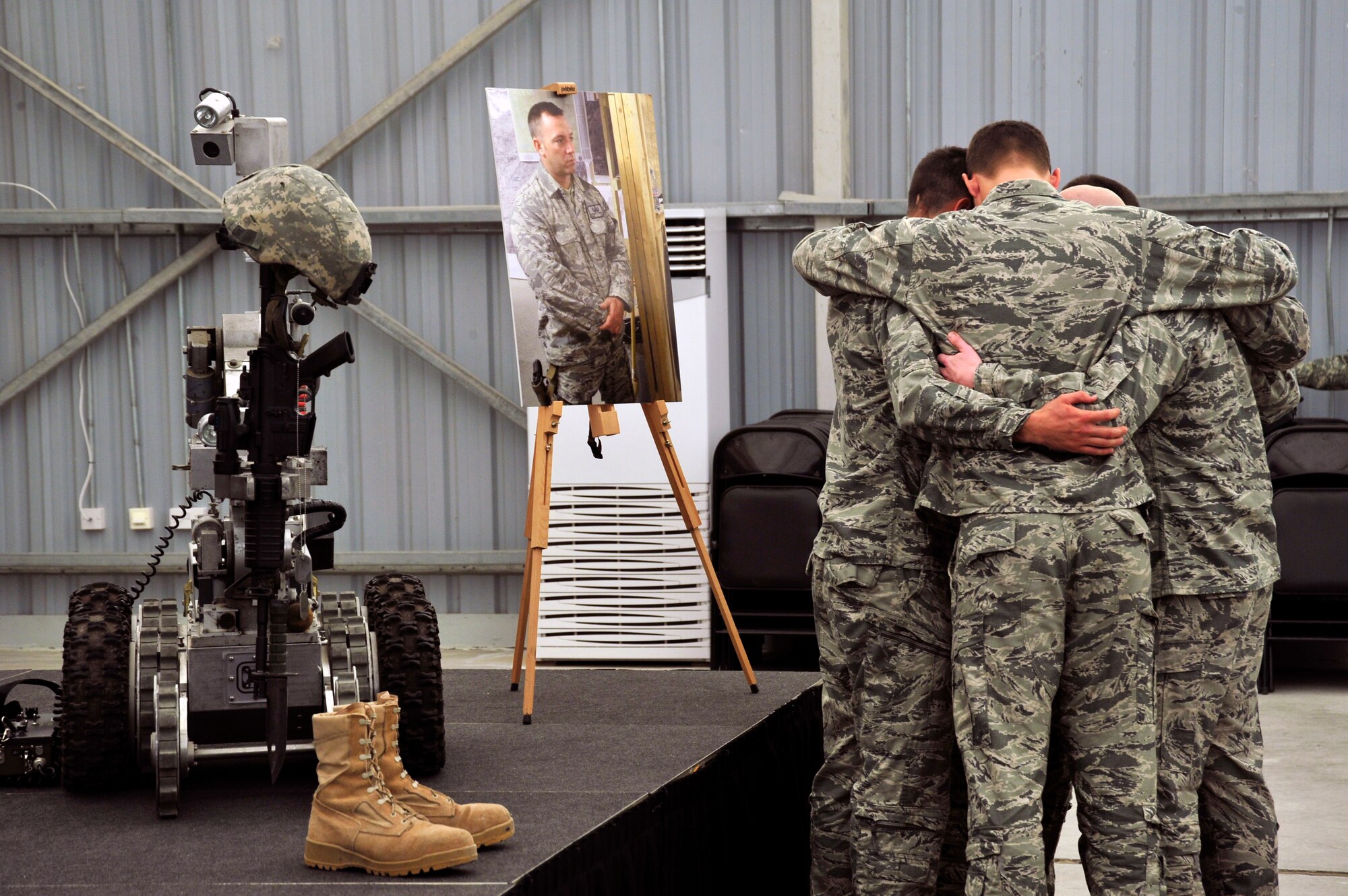 SOUTHWEST ASIA - 380th Expeditionary Civil Engineer Squadron explosive ordnance disposal team members hug as a group during a memorial ceremony Dec. 18, 2009. The ceremony was in remembrance of Tech. Sgt. Anthony Campbell Jr., 380th Expeditionary Civil Engineer Squadron, who was killed in action while forward-deployed as an explosive ordnance disposal member in Afghanistan. (U.S. Air Force photo/Tech. Sgt. Charles Larkin Sr)