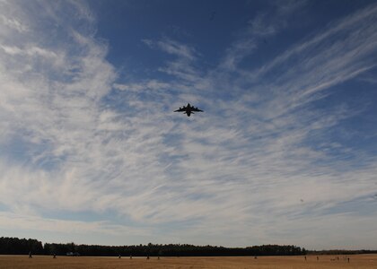 A Charleston C-17 flies over North Auxiliary Airfield near Northern S.C., Dec. 16, 2009 during a strategic brigade airdrop exercise, demonstrating the global projection of U.S. airpower. Soldiers from the 2-319th Airborne Field Artillery, 82nd Airborne Division, Ft. Bragg, N.C., were airdropped along with cargo pallets to simulate the seizure of a remote airfield, providing a joint training opportunity for the Airmen and Soldiers. (U.S. Air Force photo/Senior Airman Katie Gieratz)(Released)