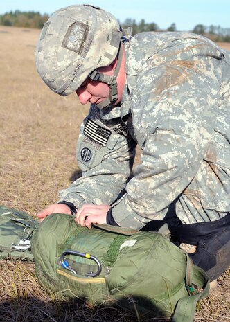 Staff Sgt. Daniel Freeman prepares to pack up his shoot after being airdropped during a strategic brigade airdrop exercise over North Auxiliary Airfield near Northern, S.C., Dec. 16, 2009. The Soldiers were airdropped along with cargo pallets to simulate the seizure of a remote airfield, providing a join training opportunity for the Airmen and Soldiers. The training mission also included cargo airdrops over North Auxiliary Airfield, aerial refueling training and simulated aeromedical evacuation. Freeman is with the 82.d Airborne Division, Ft. Bragg, N.C. (U.S. Air Force photo/Senior Airman Katie Gieratz)(Released)