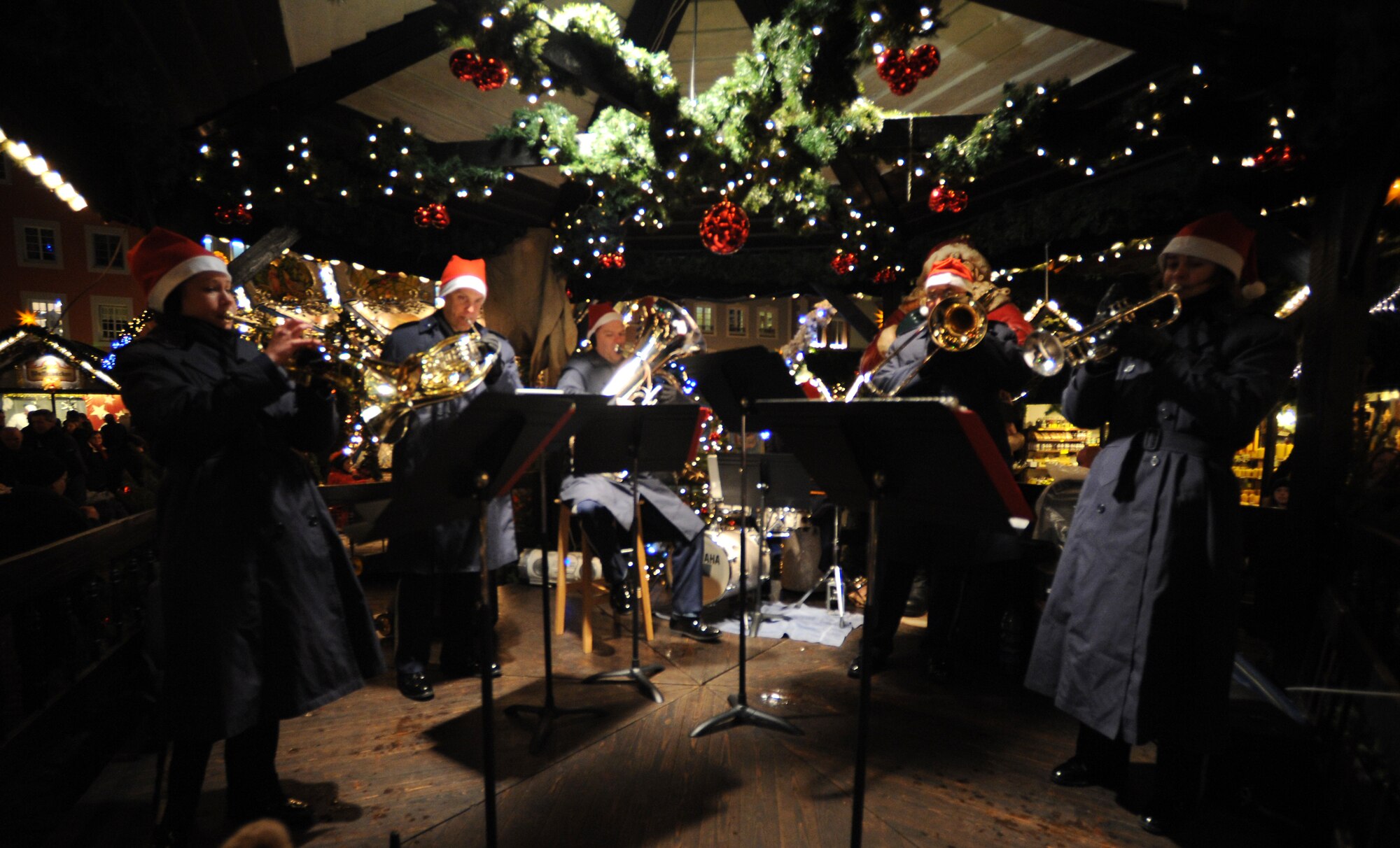 TRIER, Germany -- Members of the U.S. Air Forces in Europe Band Five Star Brass perform on the center stage Dec. 17 at the Trier Christmas Market. The band entertained crowds of all ages with holiday songs during the concert. (U.S. Air Force photo/Airman 1st Class Nathanael Callon)