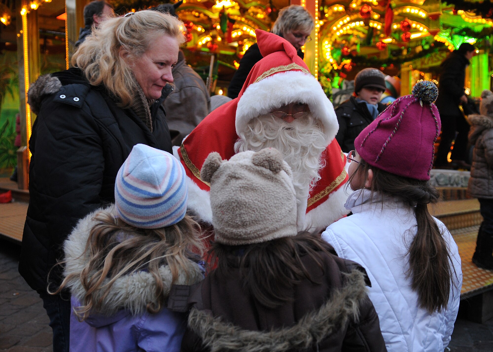 TRIER, Germany -- Santa Claus asks children what they would like for Christmas Dec. 17 at the Trier Christmas Market. The Airman and Family Readiness Center invited the spouses and children of deployed servicemembers to tour the market and enjoy the German culture. (U.S. Air Force photo/Airman 1st Class Nathanael Callon)