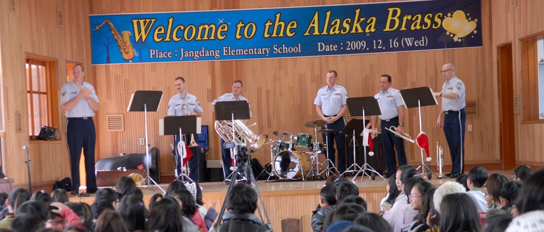 The Alaska Brass band speaks to students at Jangdang Elementary School during a performance there Dec. 16. The Alaska Brass visited Osan Air Base and its surrounding areas Dec. 14-19. (U.S. Air Force photo by Staff Sgt. Terri Barriere)