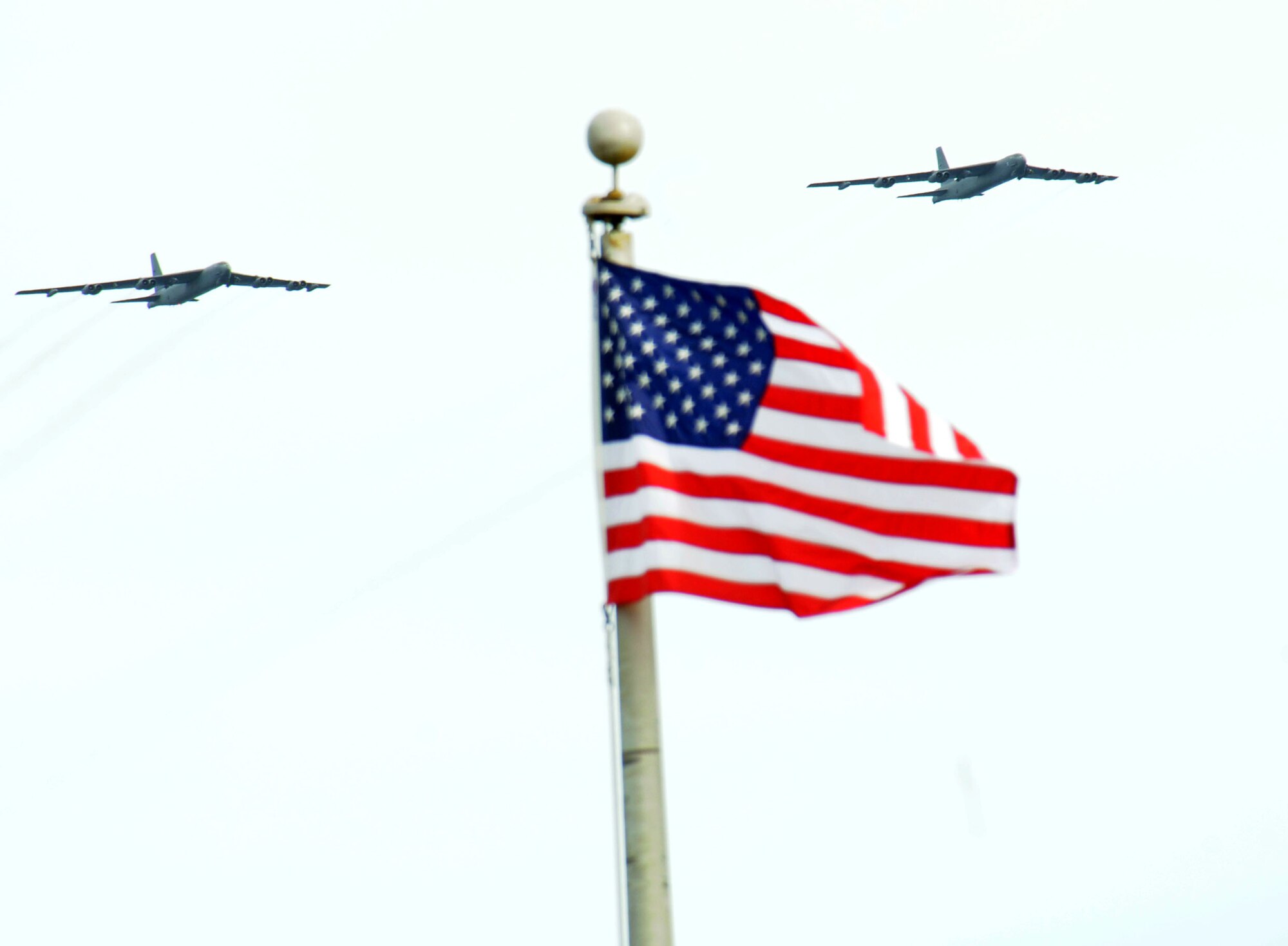 ANDERSEN AIR FORCE BACE, Guam - Two B-52 Stratofortresses fly over the Operation Linebacker II Ceremony at the Arc Light Memorial Park here Dec. 18. The ceremony commemorates the 37th anniversary of the campaign that led to the end of the Vietnam War. (U.S. Air Force Photo by Airman 1st Class Julian North)