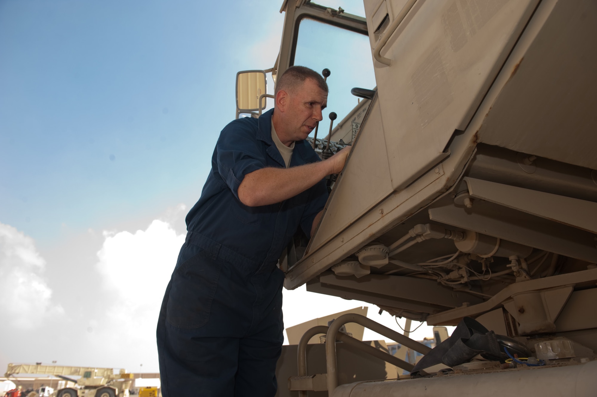 Staff Sgt. Justin Martz, 1st REDHORSE Group vehicle mechanic, replaces the seat on a piece of construction equipment, Dec. 15, 2009, in Southwest Asia. Sergeant Martz helps to maintain vehicles and pieces of equipment for REDHORSE Units throughout the U.S. Central Command area of responsibility. (U.S. Air Force photo/Staff Sgt. Robert Barney) 