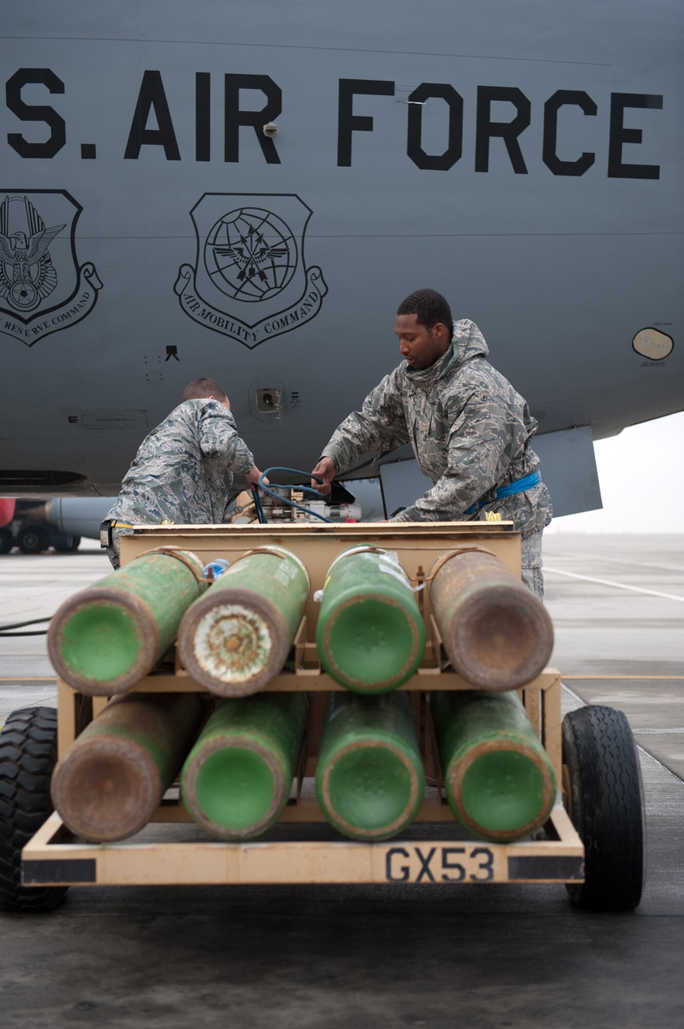 Left, Airman 1st Class Kyle Hill and Staff Sgt. Lanear Brown, 340th Aircraft Maintenance Unit crew chiefs, refill gaseous oxygen during routine servicing, Dec. 11, 2009, in Southwest Asia. Airman Hill and Sergeant Brown maintain the KC-135 Stratotankers stationed here in support of missions throughout the U.S. Central Command area of responsibility. (U.S. Air Force photo/Staff Sgt. Robert Barney) 