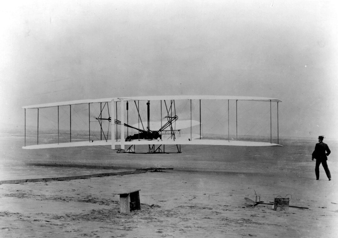 With Orville Wright at the controls, the Wright Brothers conduct the first flight by man with a motor driven, heavier-than-air machine  Dec. 17, 1903, at Kill Devil Hills near Kitty Hawk, N.C. (Courtesy photo)