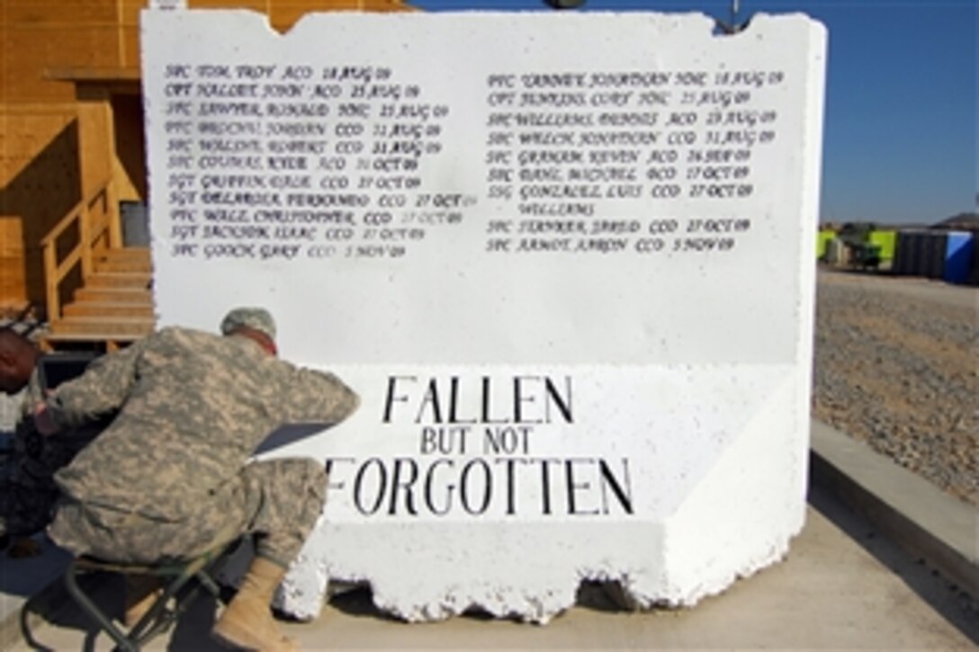 U.S. Army Sgt. Michael Shell creates a mural to memorialize the fallen comrades assigned to the 1st Battalion, 17th Infantry Regiment, Forward Operating Base Frontenac, Afghanistan, Dec. 16, 2009. 
