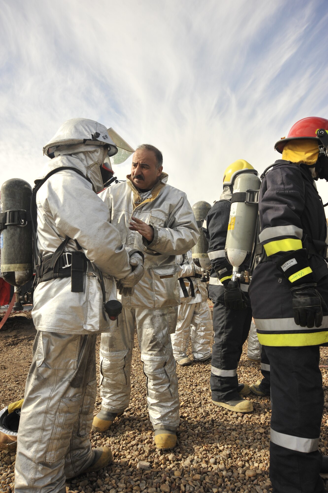 Iraqi firefighters suit up before a live training exercise north of Sather Dec. 16, 2009. The Iraqi fire fighters, who have been trained by Air Force fire fighters, demonstrated thier capabilities to Major Gen. James Hunt, Multi-National Corps- Iraq deputy commander. (U.S. Air Force photo/Senior Airman Eric Summers Jr./ released)