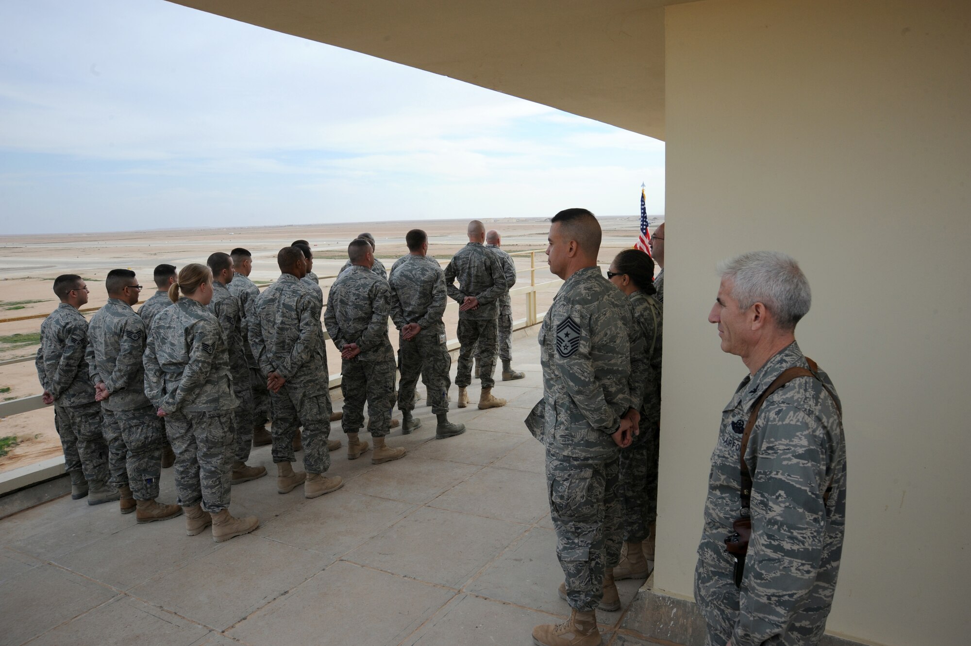 AL ASAD AIR BASE, Iraq -- Air Force Col. David Lujan (right), 332nd Expeditionary Operations Group Commander, looks out over the Al Asad airfield before the start of the assumption of command ceremony for the 532nd Expeditionary Operations Support Squadron Dec. 15, 2009. The airfield was previously operated by the U.S. Marine Corps, but due to the drawdown, the Air Force has taken over these responsibilities. (U.S. Air Force photo/Master Sgt. Trish Bunting)