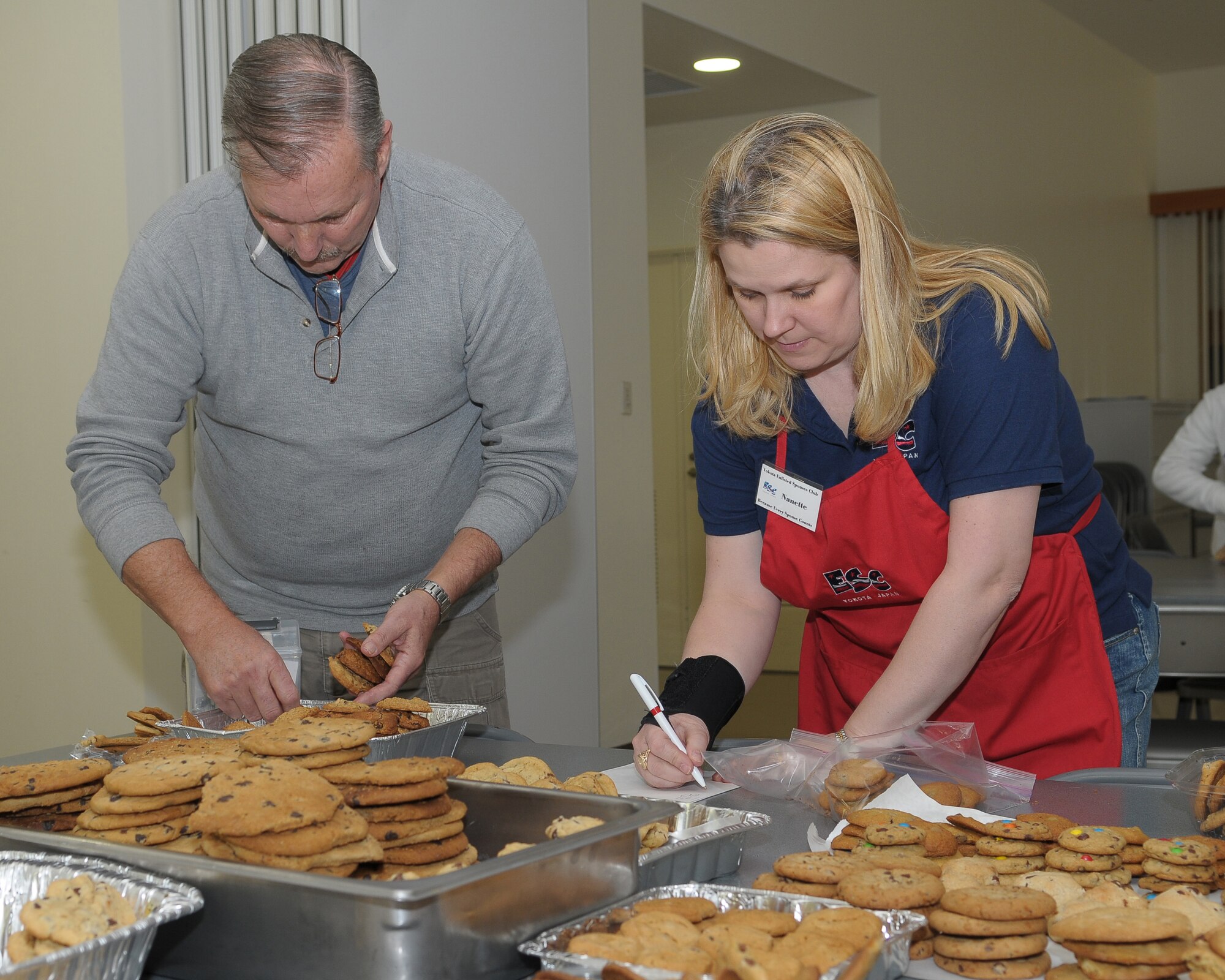 YOKOTA AIR BASE, Japan -- Bill Loveday, Cookie Crunch volunteer, and Nanette Mills, Yokota Enlisted Spouses Club member, count cookies Dec. 18 during the YESC Cookie Crunch event. More than 3,000 cookies were donated, bagged and distributed to Airmen in the dormitories by the YESC. (U.S. Air Force photo/Airman 1st Class Sean Martin)