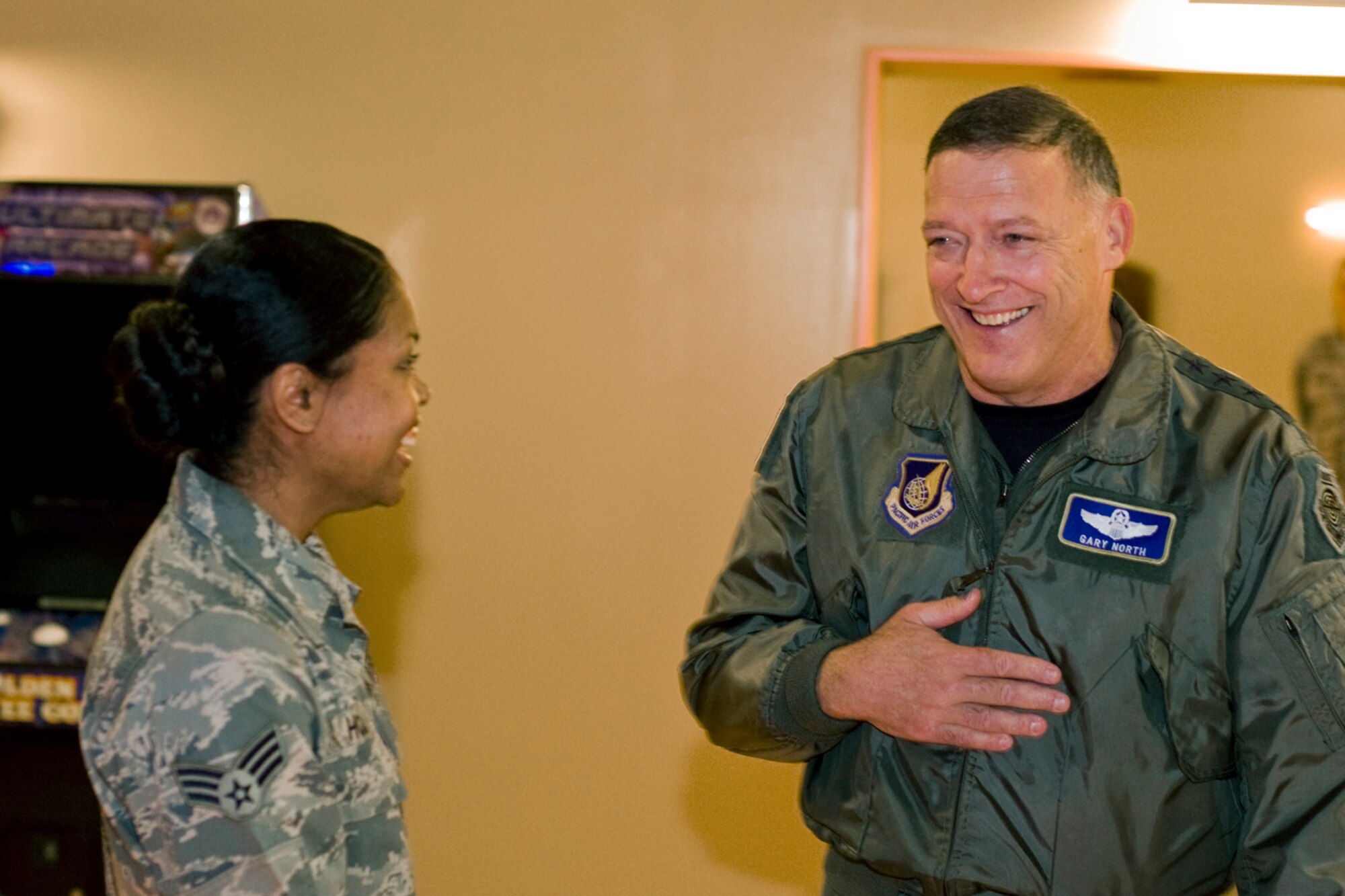 Gen. Gary North, Pacific Air Forces commander, shares a laugh with Senior Airman Victoria Hobbs, 35th Logistics Readiness Squadron supply journeyman, during his tour of the Airmen’s Center Dec. 15 at Misawa Air Base, Japan. Airman Hobbs was part of the initial committee that assisted in planning for the newly renovated center and was coined by General North for her contributions. (U.S. Air Force photo/Senior Airman Jamal D. Sutter)