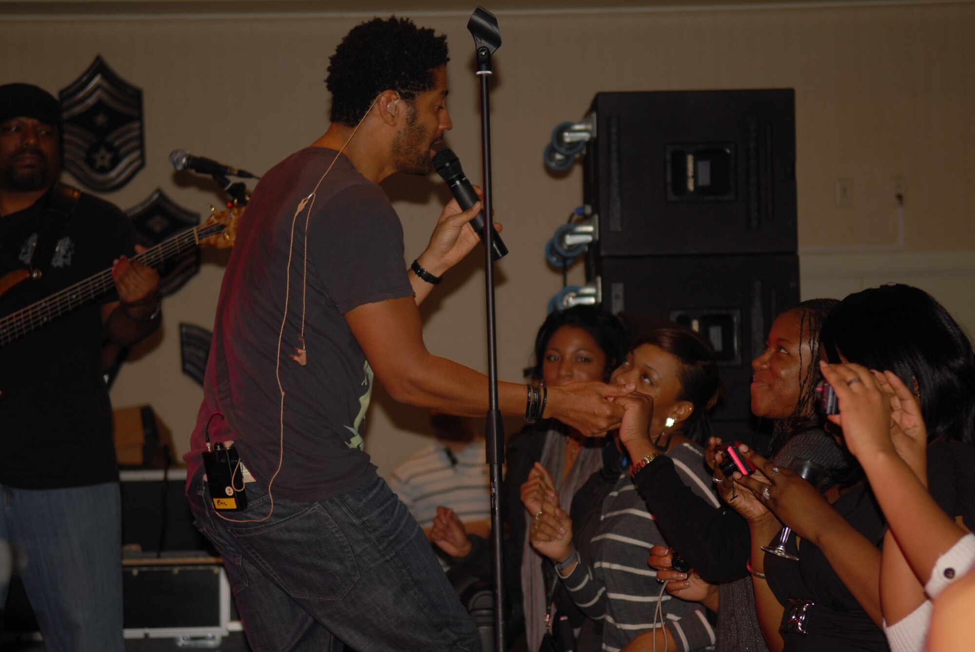 KUNSAN AIR BASE, Republic of Korea -- R and B recording artist Eric Benet sings to a crowd of more than 150 during a concert at the Loring Club here Dec. 15. Mr. Benet stopped by the Wolf Pack during his Pacific Armed Forces Entertainment tour. After the show, Mr. Benet took time to sign autographs and take pictures with Wolf Pack members. (U.S. Air Force photo by/Staff Sgt. Patrice Clarke)