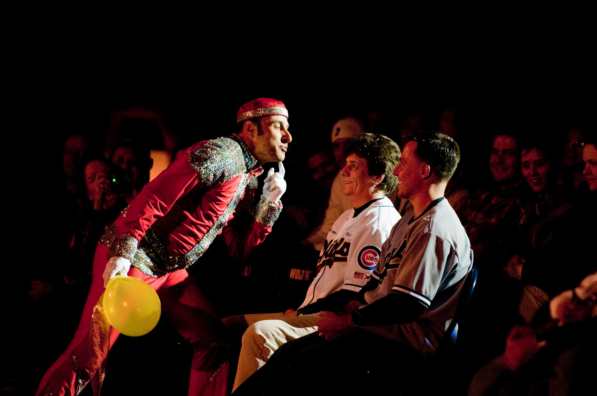KUNSAN AIR BASE, Republic of Korea -- A performer with the Cirque Dreams Holidaze show asks Chief Master Sgt. Nancy Judge, 8th Fighter Wing acting command chief, for a kiss during the show here Dec. 8. The Cirque Dreams Holidaze show, which was brought here as part of the Pacific Armed Forces Entertainment tour, featured an international cast of acrobats, aerialists and dancers displaying the wonders of the holidays. (U.S. Air Force photo by/ Senior Airman Jonathon Steffen)