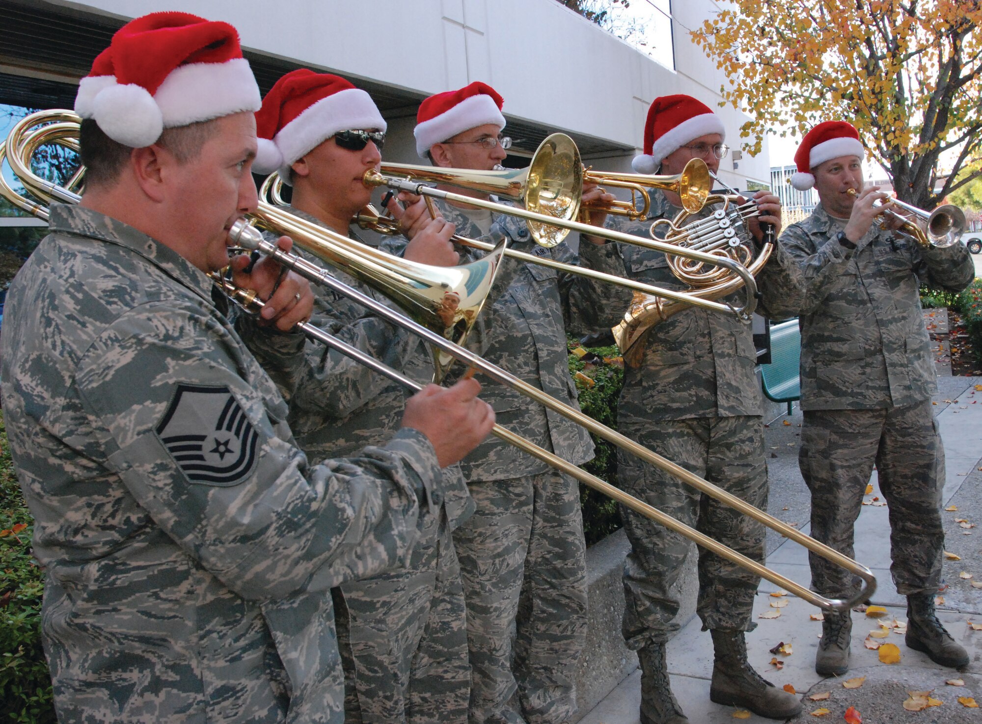 The Air Force Band of the Golden West warms up at the Moreno Valley City Hall, which was their tenth and final Christmas caroling performance Tuesday, Dec. 15. The brass quintet consists of (from left to right) Master Sgt. Matt Baloun playing bass trombone in place of a tuba, Airman 1st Class Ryan Torronez on trombone, Tech. Sgt. John Ruff on trumpet, Tech. Sgt. Thomas Hanrahan on French horn and Tech. Sgt. Ed Schubert on second trumpet. The band spent the day at March ARB spreading holiday cheer to various units around base. “This is our way of thanking the military members for all the hard work they do and the local community for their support of the base,” said Master Sgt. Baloun. March was the first stop for the band which then played at Los Angeles AFB on Wednesday and Vandenberg AFB on Thursday. (U.S. Air Force photo by Staff Sgt. Megan Crusher)
