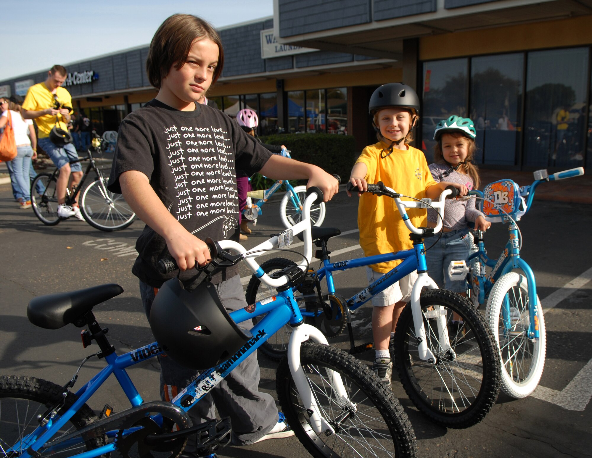 LOMPOC, Calif. -- Jason Cassim, Gabriel Cassim and Briana Cassim, children of Tech. Sgt. Shawn Cassim, pose with their new bikes Saturday, Dec. 19, 2009, here. The bikes and helmets were provided by the Village Dirtbags to families of Vandenberg’s deployed servicemembers.  The family names were provided by Vandenberg's Global Hearts, which coordinated the names of the children, height and gender. (U.S. Air Force photo/Airman 1st Class Kerelin Molina)
