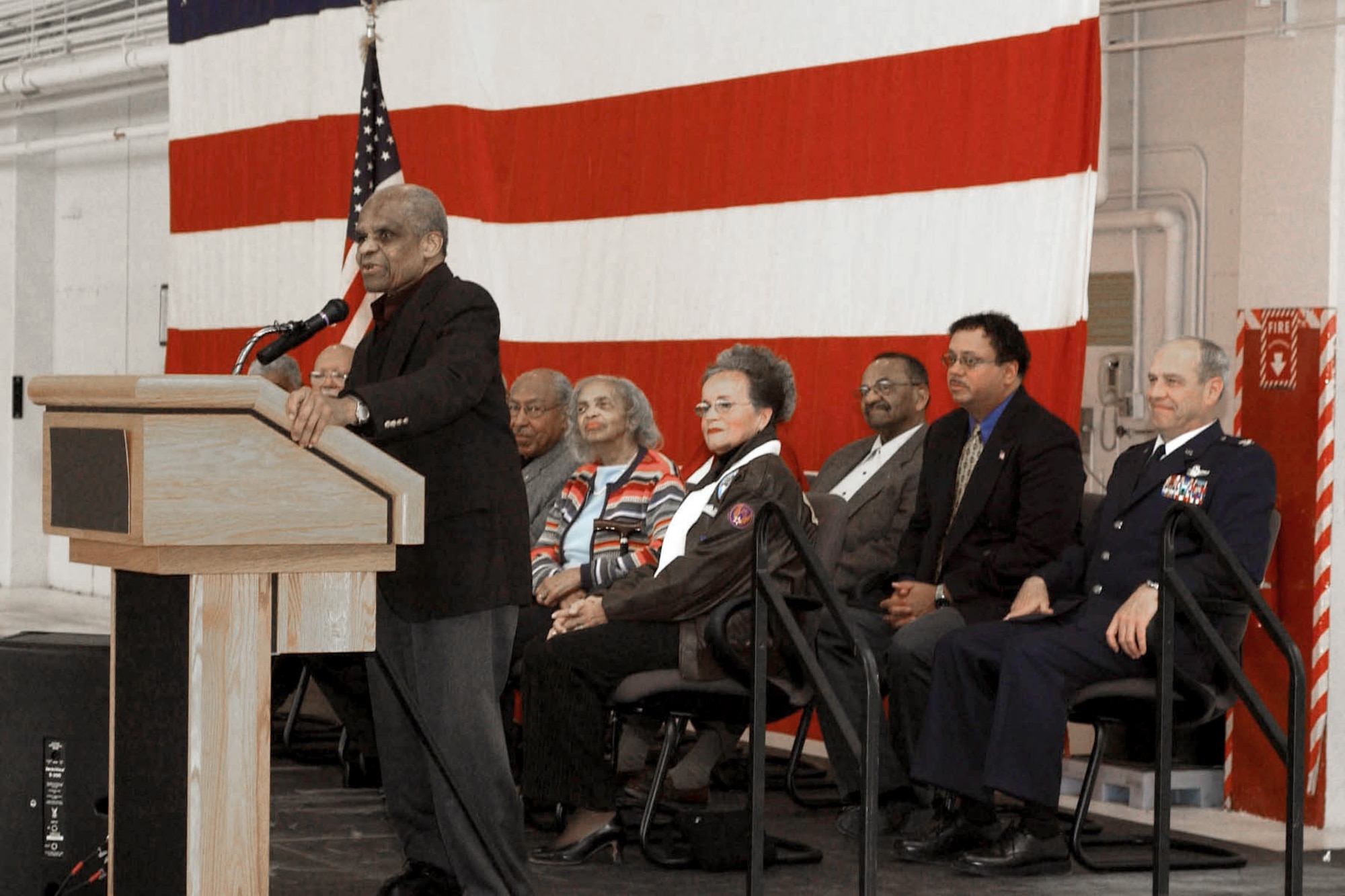 Capt. Luther Smith speaks to a crowd of 300 gathered for the dedication ceremony of the Iowa Tuskegee Airmen Memorial held at the 132nd Fighter Wing, Des Moines Iowa, November 9, 2002. Capt. Smith's plane number and name adorn the fiberglass P-51D replica that will be on static display at the main entrance of the 132nd Fighter Wing. The memorial is dedicated to all of Iowa's Tuskegee Airmen. The Iowa Tuskegee Airmen Memorial is a joint project between the Fort Des Moines Museum And Education Center and the Iowa Air National Guard. (U.S. Air Force photo/Senior Master Sgt. Tim Day)(released)