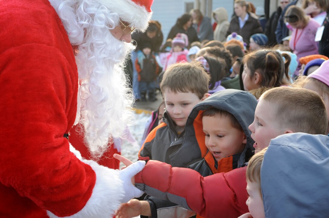 ELLSWORTH AIR FORCE BASE, S.D.-- Children of the Youth and Family Services child care center greet Santa at the YFS child care center in Rapid City, S.D., Dec. 17. Santa, also known as Master Sgt. Cary Loeffler, 28th Operations Support Squadron Aircrew Fight Equipment assistant superintendent, and his wife began the “Angel Tree Program” at Ellsworth Air Force Base by introducing a traveling tree throughout the 28 OSS Squadron. (US Air Force photo/Airman 1st Class Corey Hook)