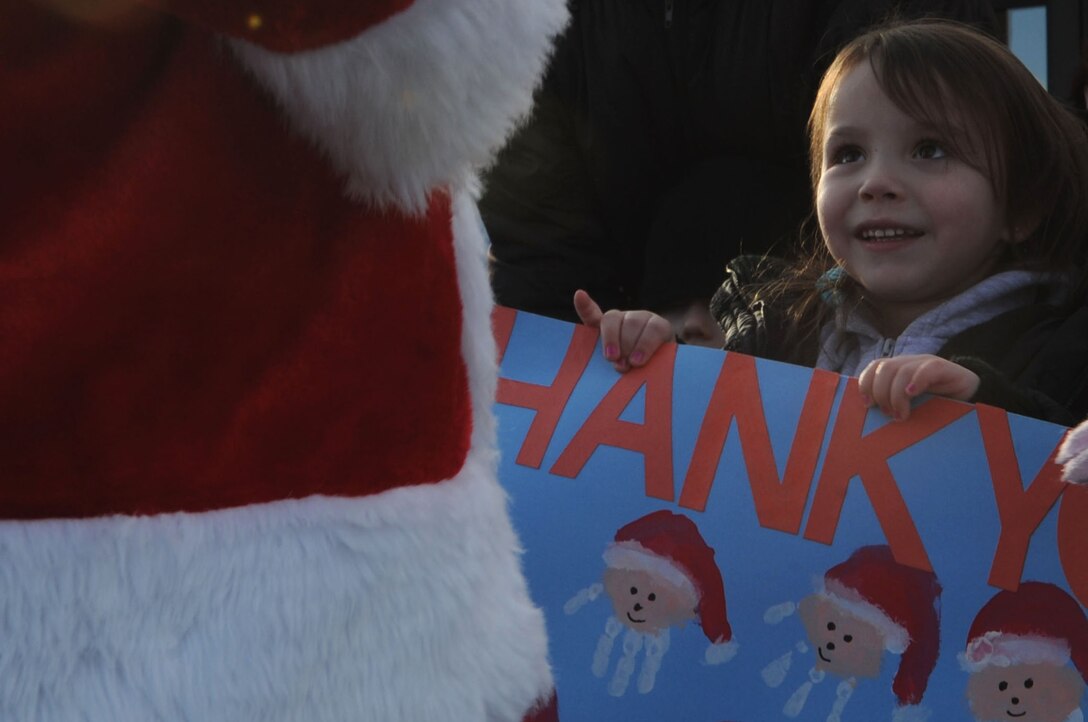 ELLSWORTH AIR FORCE BASE, S.D.-- Rubi R., a child enrolled in the Youth and Family Services child care center, smiles in excitement while seeing Santa at the YFS child care center in Rapid City, S.D., Dec. 17. This is the third time Santa, Mrs. Claus and Ellsworth Airmen bought, wrapped and delivered gifts for every child at the YFS child care center. (US Air Force photo/Airman 1st Class Corey Hook)