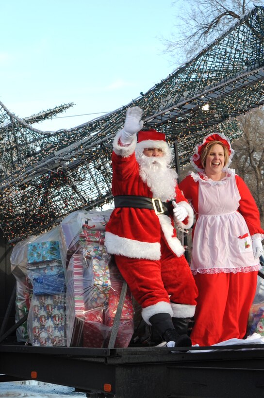 ELLSWORTH AIR FORCE BASE, S.D.-- Santa and Mrs. Claus arrive at the Youth and Family Services child care center in Rapid City, S.D., Dec. 17. Santa, also known as Master Sgt. Cary Loeffler, 28th Operations Support Squadron Aircrew Fight Equipment assistant superintendent, and his wife began the “Angel Tree Program” at Ellsworth Air Force Base by introducing a traveling tree throughout the 28 OSS Squadron. (US Air Force photo/Airman 1st Class Corey Hook)