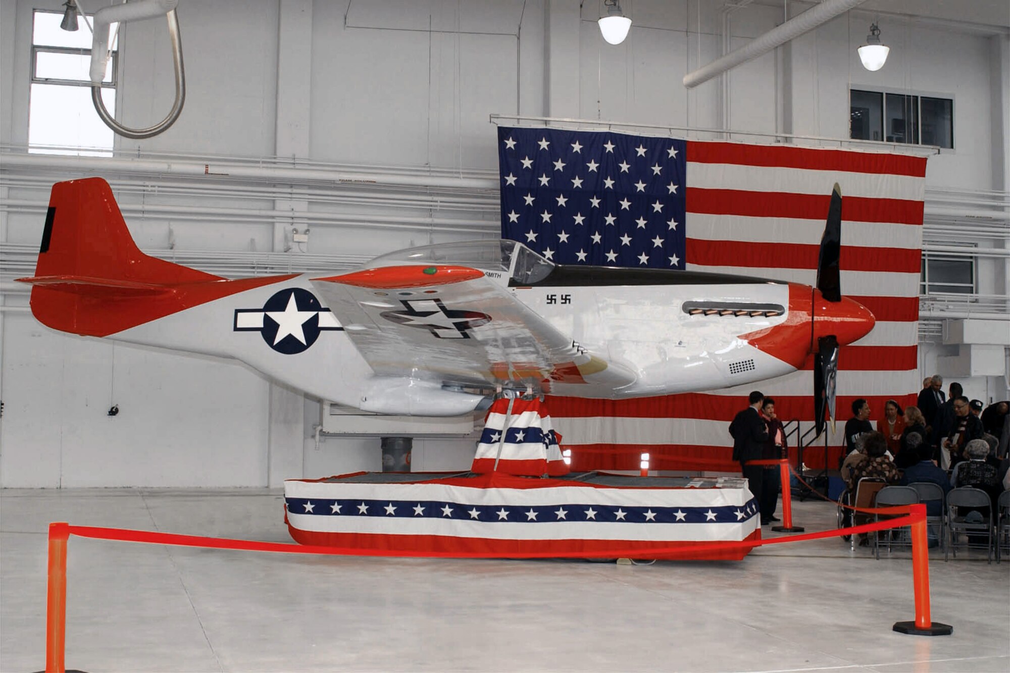 A replica P-51D unveiled during a dedication ceremony held at the 132nd Fighter Wing, Des Moines, Iowa, on November 9, 2002. The P-51D classically painted as a "Red Tail Angel", identified to all that the aircraft was being flown by the famed Tuskegee Airman of the 332nd Fighter Group. The P-51D will be on static display at the new main entrance of the 132nd Fighter Wing as the Iowa Tuskegee Airmen Memorial.  The Mustang bears the names and numbers of two of Iowa's most famous flyers, number 93, flown by Capt. Robert Williams (Williams wrote the original manuscript for the 1995 HBO film "The Tuskegee Airmen") and number 10, flown by Capt. Luther Smith (Smith survived being shot down and held captive by the Germans with life threatening wounds). (U.S. Air Force photo/Senior Master Sgt. Tim Day)(released) 