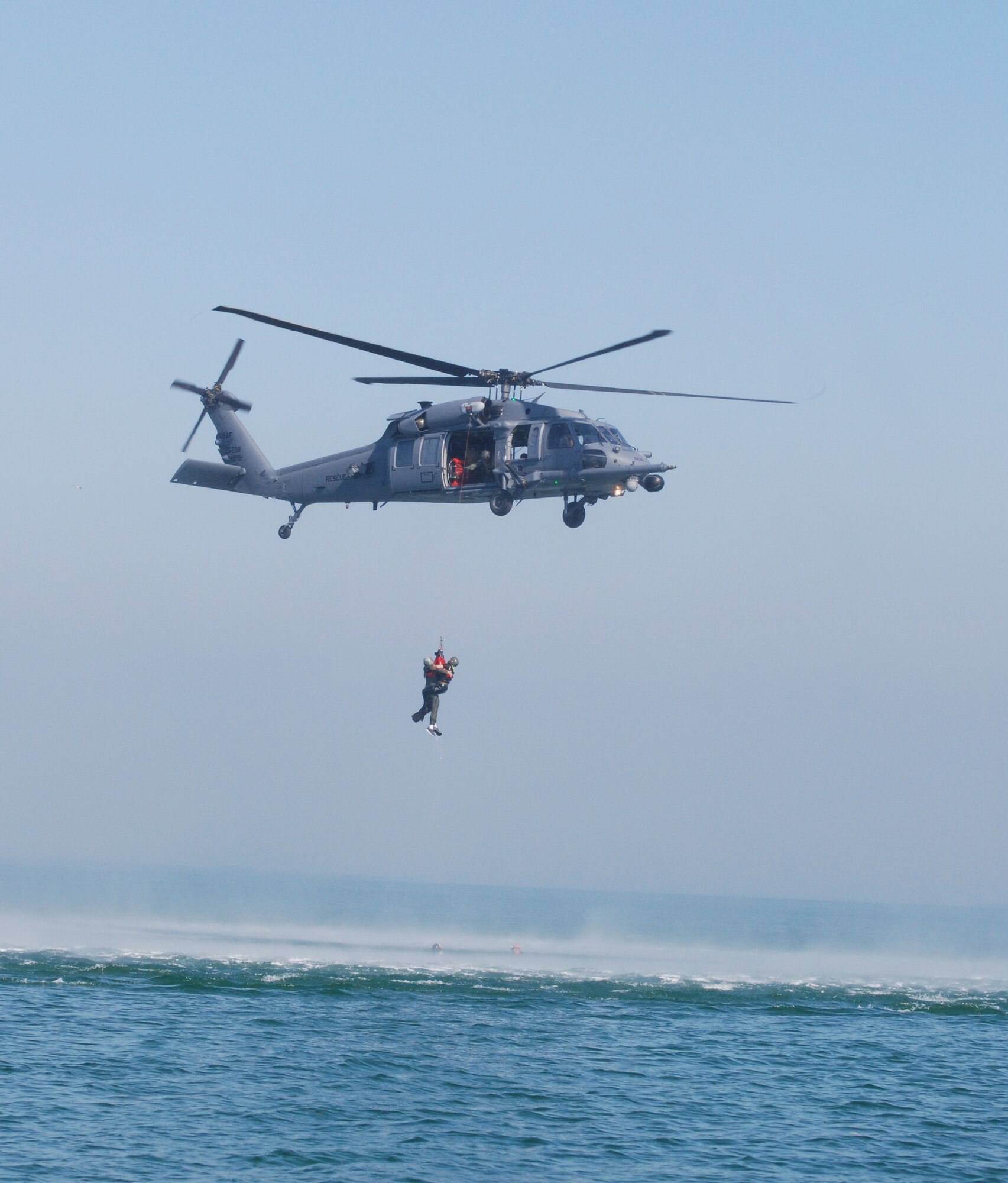 Key West, Fla. - Reserve  Pararescuemen (PJs) from the 920th Rescue Wing, Patrick Air Force Base, hoist a "survivor" from the water during the 2009 SAREX. Once onboard, the PJs administer the appropriate medical treatment as needed. All PJs are EMT/Paramedic qualified. (U.S. Air Force Photo/Staff Sgt. Leslie Kraushaar)