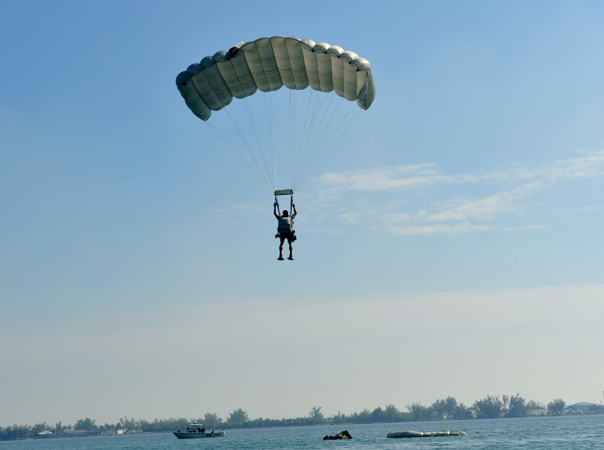 Key West, Fla. - An  Air Force Reserve Pararescueman from the 920th Rescue Wing lands near the rigged alternate method zodiac (RAMZ). From here, it is a group effort to unload the 16 ft-zodiac and get it ready for rescue. (U.S. Air Force Photo/Staff Sgt. Leslie Kraushaar)
