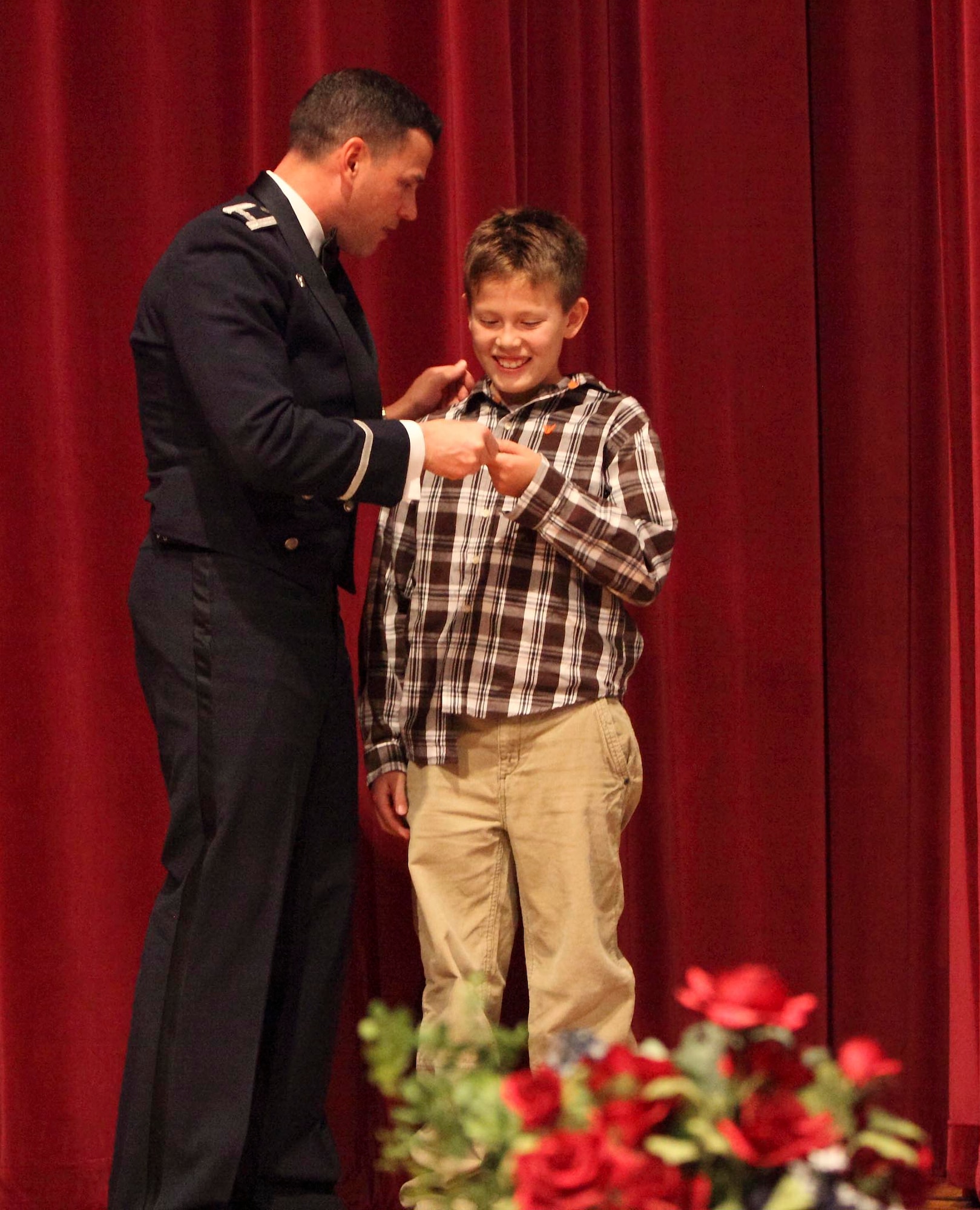 Col. Matthew "Zap" Molloy, left, presents a set of wings to Reid Roberts Dec. 18 before Euro-NATO Joint Jet Pilot Training Program graduates receive theirs. Reid's father, Capt. Jason Roberts, was a graduate of the class. (U.S. Air Force photo/Lt. Col. Ternell Washington)