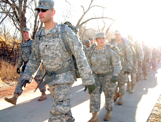 Soldiers from Fort Carson walk on a path near Dorchester Park in Colorado Springs, Colo., to give supplies to homeless residents at the Marian House soup kitchen in Colorado Springs, Colo., Dec. 18, 2009. The volunteer project, organized by Fort Carson chaplains, started as a 12-person detail and grew into a volunteer project for more than 300 Soldiers. Several charities in Colorado Springs rely on assistance from military volunteers. (U.S. Air Force photo/Staff Sgt. Don Branum)