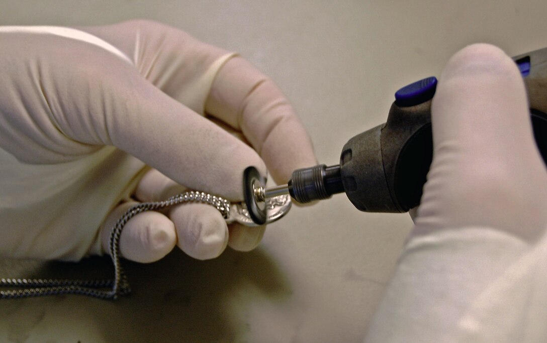 Medals like this and other personal effects are cleaned and restored as
much as possible by Tech. Sgt. Gary Fernandes and other members of the Air
Force Mortuary Affairs Operations Center at Dover Air Force Base, Del.  They
are then either given to the person escorting the fallen servicemember to
their final destination so they can be presented to the family, or taken to
the Joint Personal Effects Depot at Aberdeen, Md., for further restoration
or storage. Sergeant Fernandes and 13 other 914th Services Squadron members
are currently deployed to the center.  (U.S. Air Force photo by Ed Drohan)

