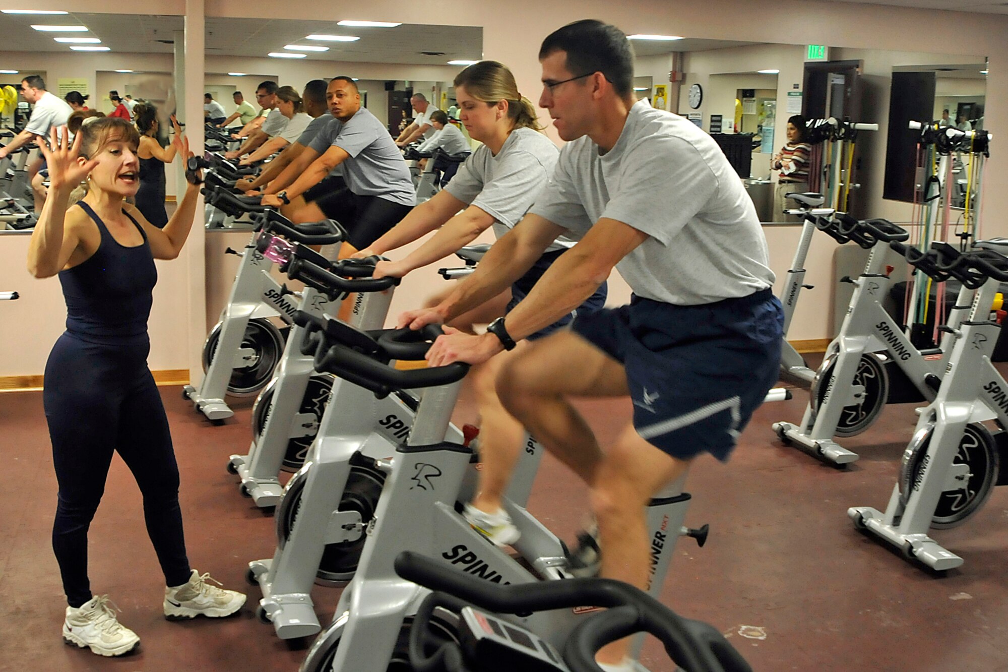 Cindy White, chief of health promotion at the Health and Wellness Center, leads Airmen, (from left) Tech. Sgt. Alex Martin, 21st Operations Support Squadron; Senior Master Sgt. Diane Henderson, Air Force Space Command inspector general’s office; and Maj. Chuck Hancox, AFSPC space operations testing and evaluation, through a “F2F: Be Ready” fitness class Dec. 10 at the HAWC, Building 560. Airmen learned techniques on how to maximize their workouts. Fitness programs at the HAWC incorporate the new Air Force culture of fitness, which is to help Airmen achieve and maintain healthy and fit lifestyles year-round, not just for annual PT tests. (Air Force photo by Dennis Howk)
