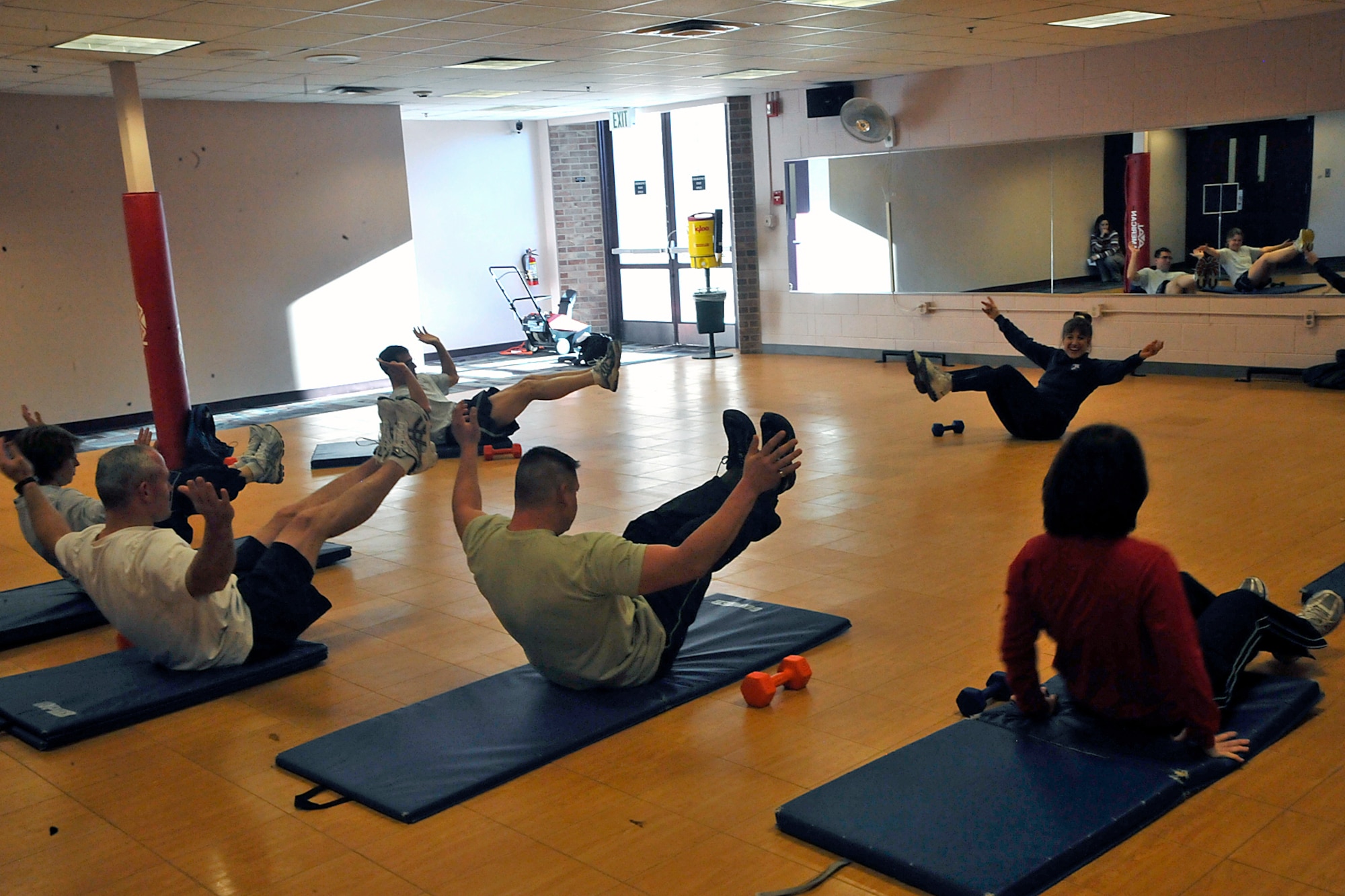 Cindy White, chief of health promotion at the Health and Wellness Center, leads Airmen through abdominal exercises Dec. 10 during a “F2F: Be Ready” fitness class at the HAWC, Building 560. Ms. White showed Airmen exercises to help maximize their workouts. Fitness programs at the HAWC incorporate the new Air Force culture of fitness, which is to help Airmen achieve and maintain healthy and fit lifestyles year-round, not just for annual PT tests. (Air Force photo by Dennis Howk)